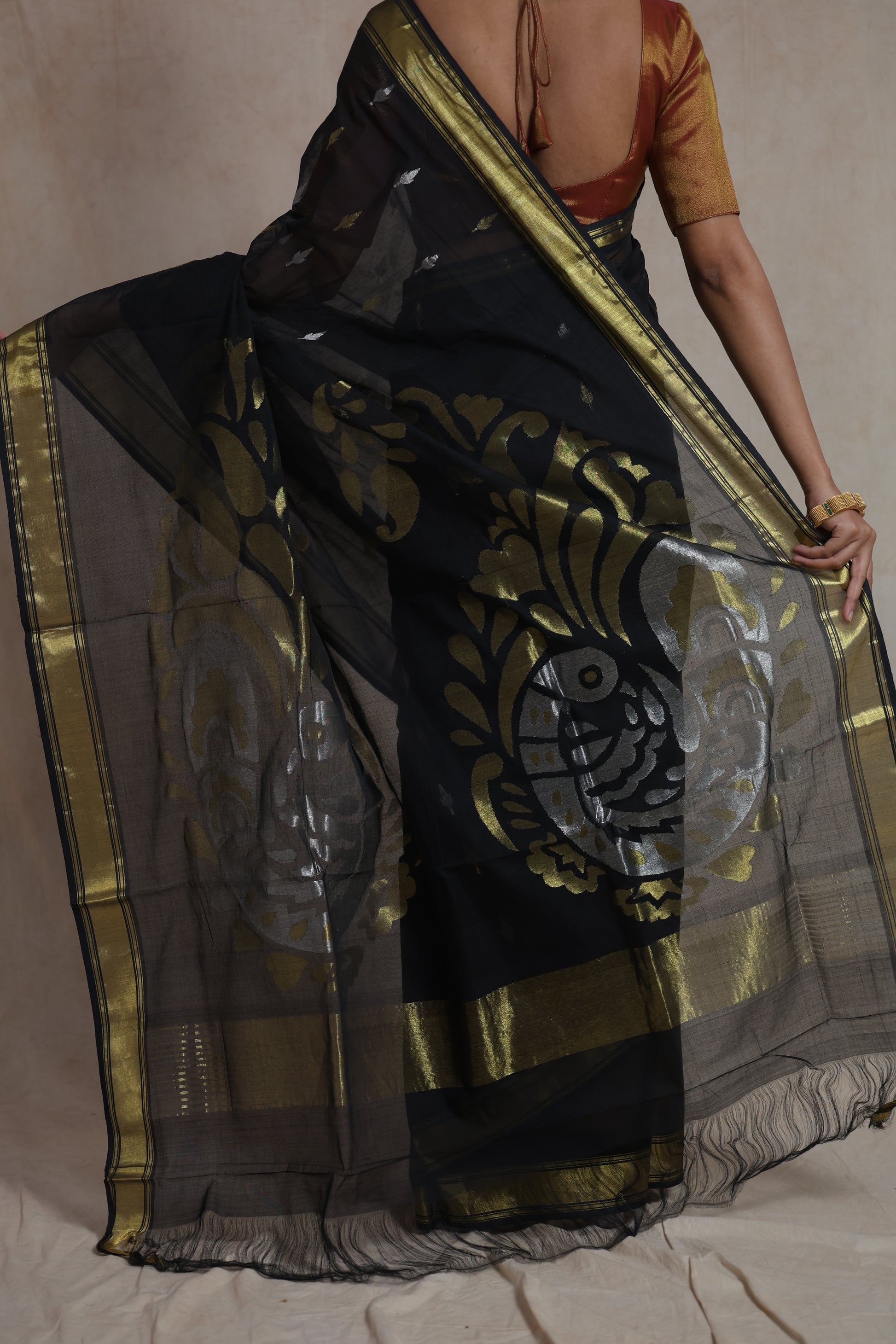 Back view showcasing the artistic woven pallu of black Kanchipuram cotton saree