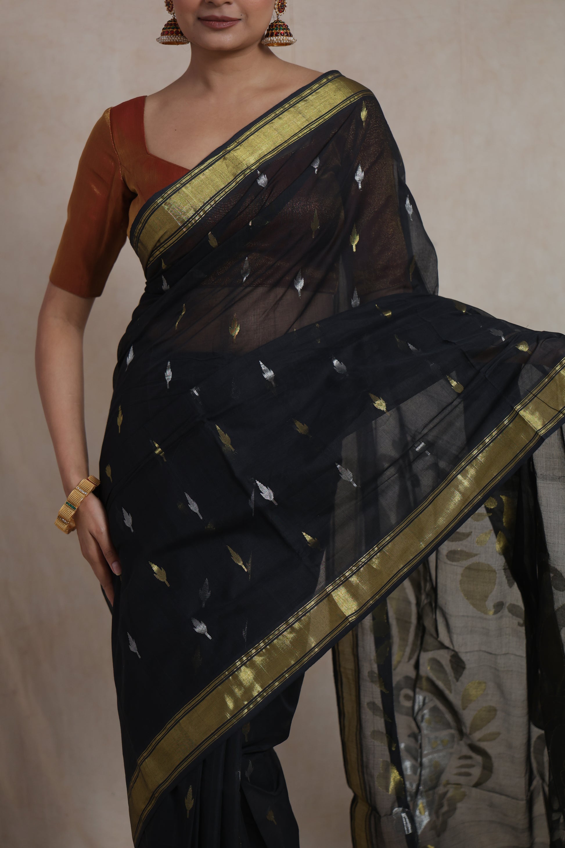 Detailed view of the statement pallu with traditional artistic woven design