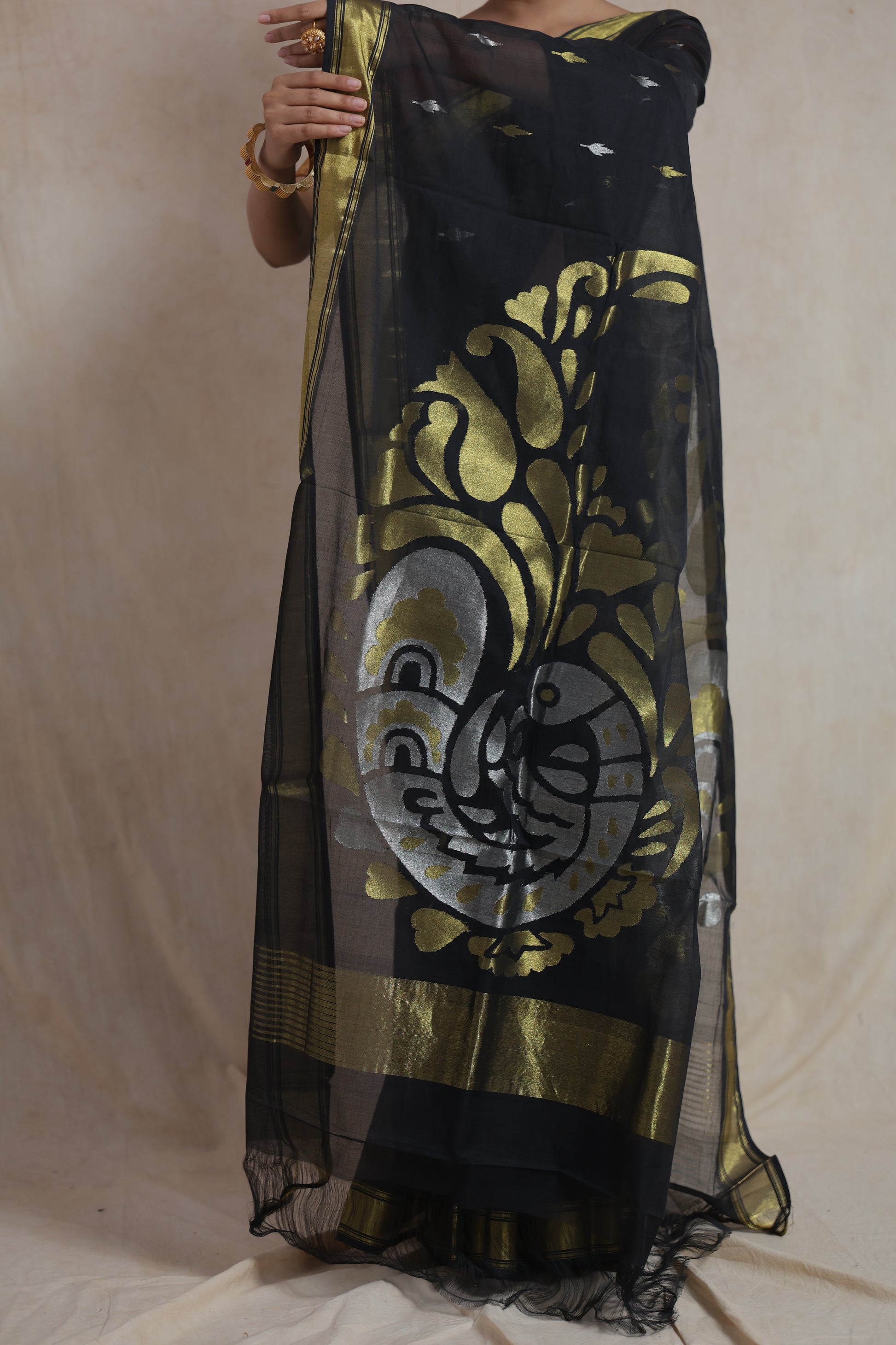 Full display of the decorative woven pallu and border of black Kanchipuram cotton saree