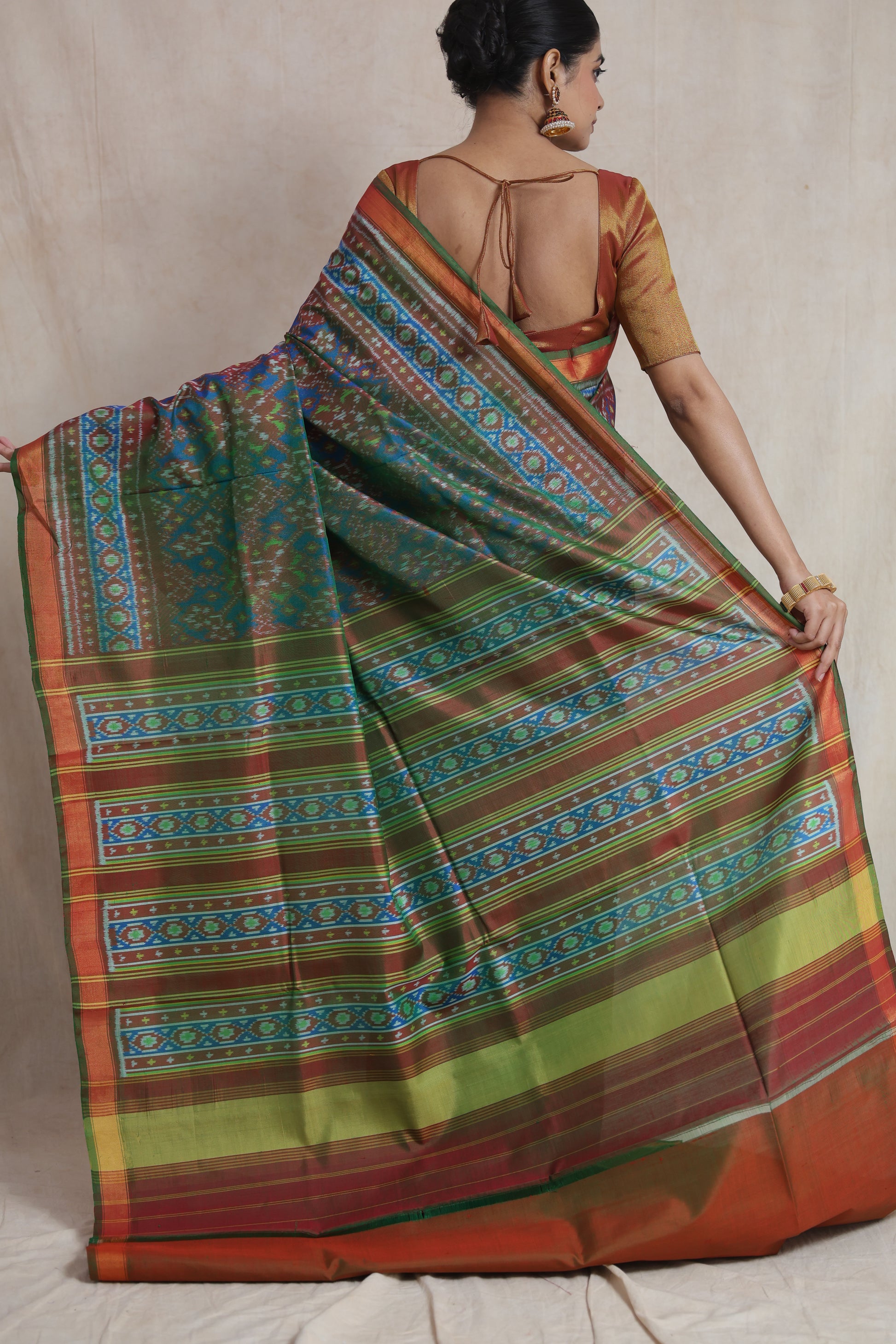 Back view of Patola handloom silk saree displaying richly woven pallu and traditional motifs