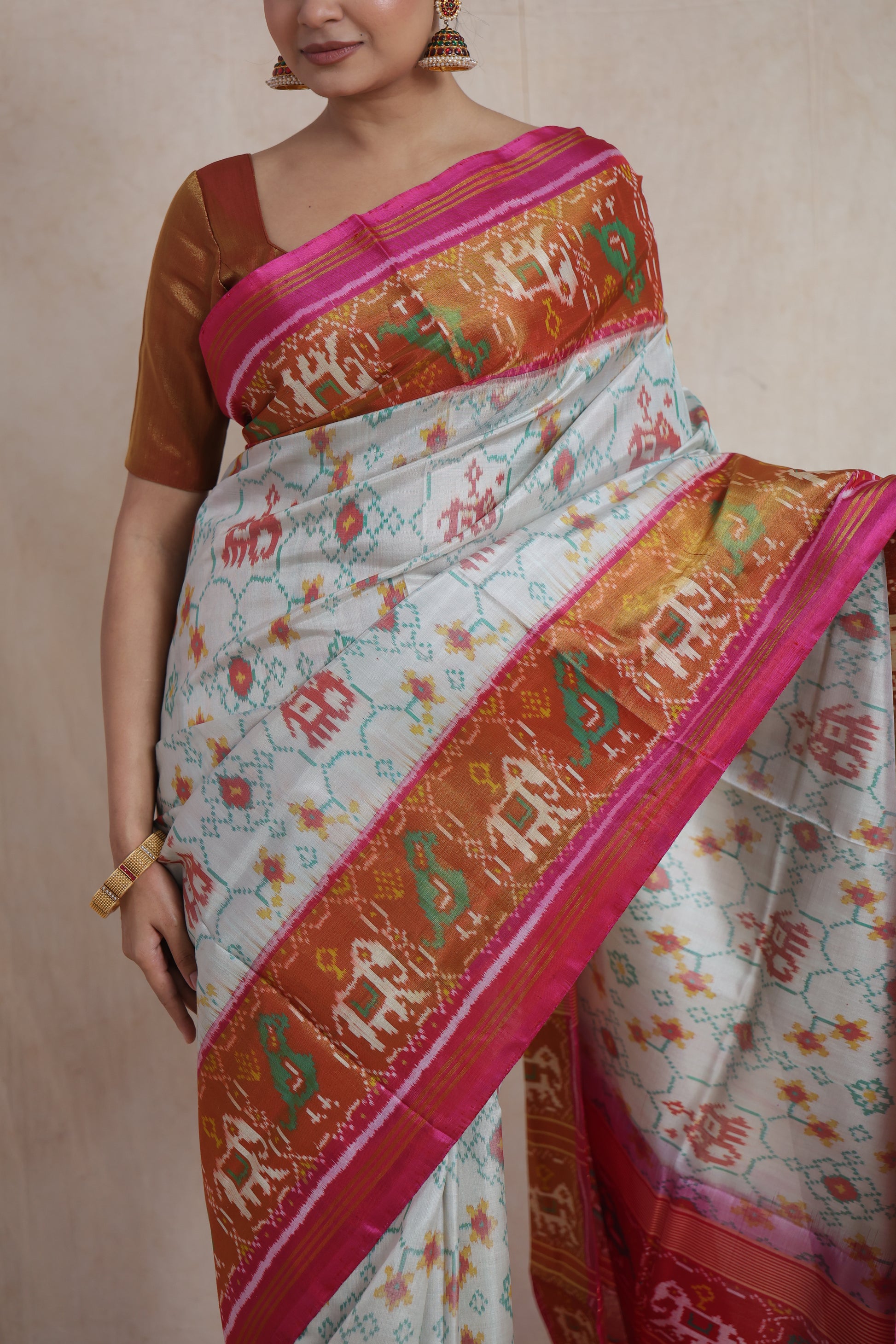 Close-up of ivory Patola silk saree showcasing traditional Ikat motifs