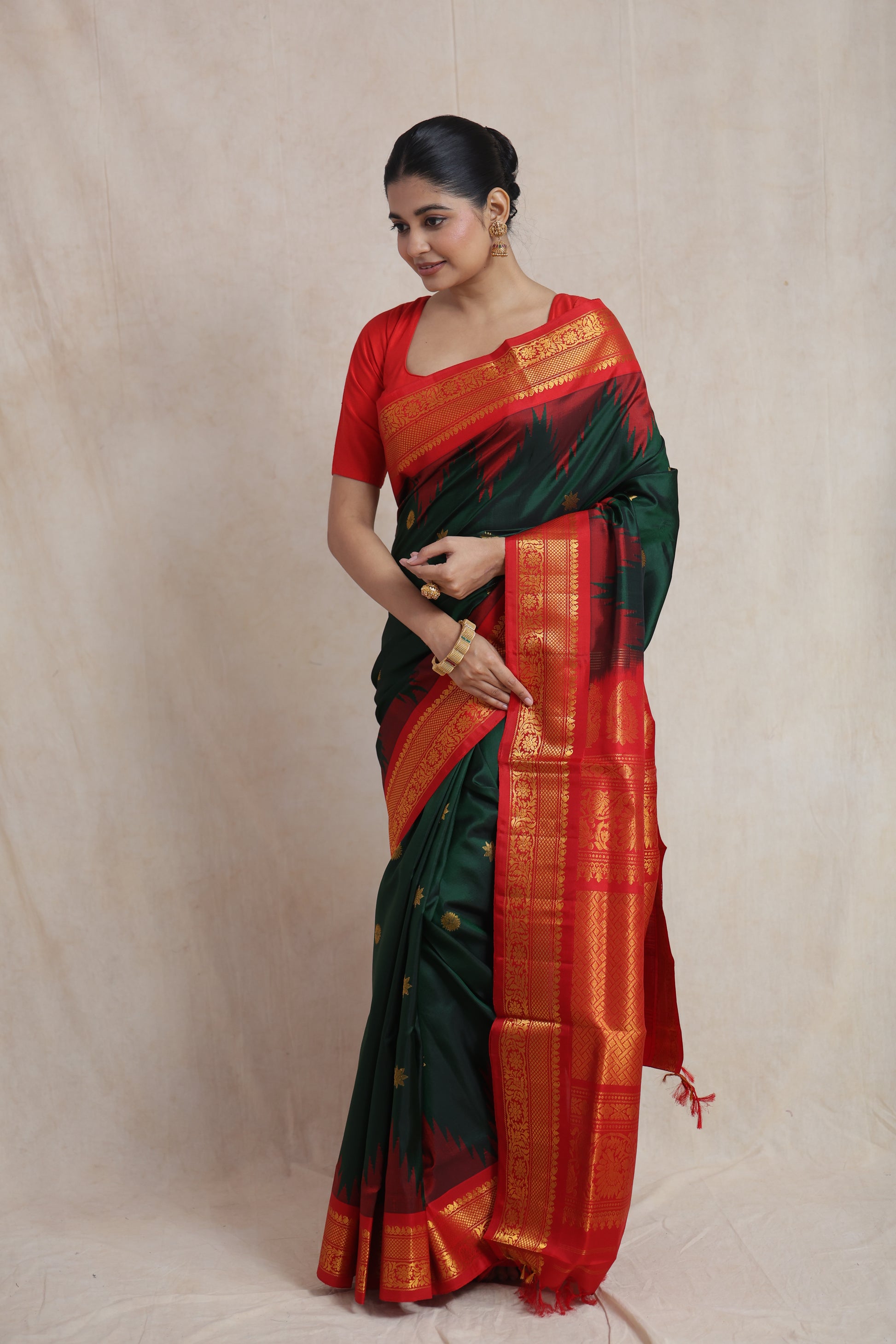 Rich crimson red pallu of forest green Gadwal silk saree with traditional weaving