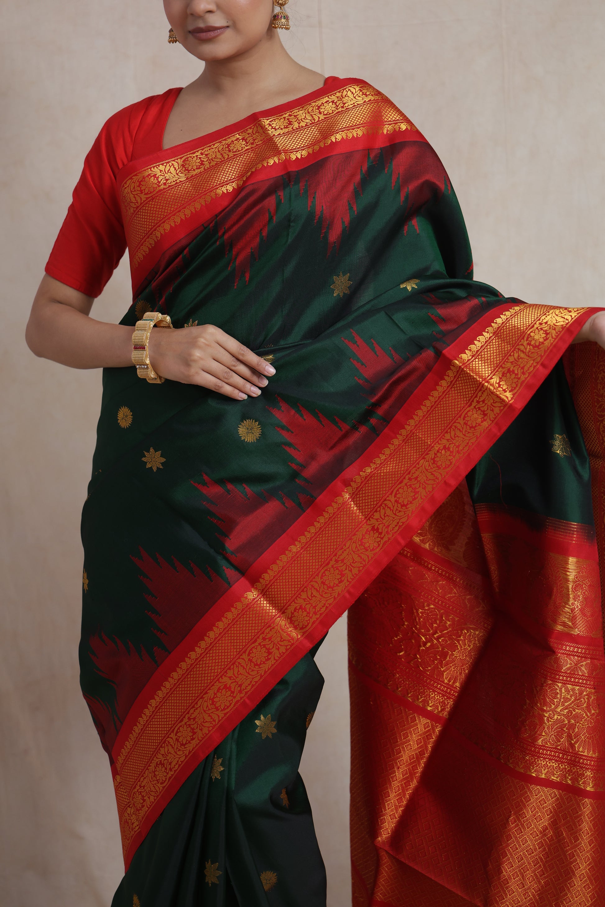 Rich crimson red pallu of forest green Gadwal silk saree with traditional weaving
