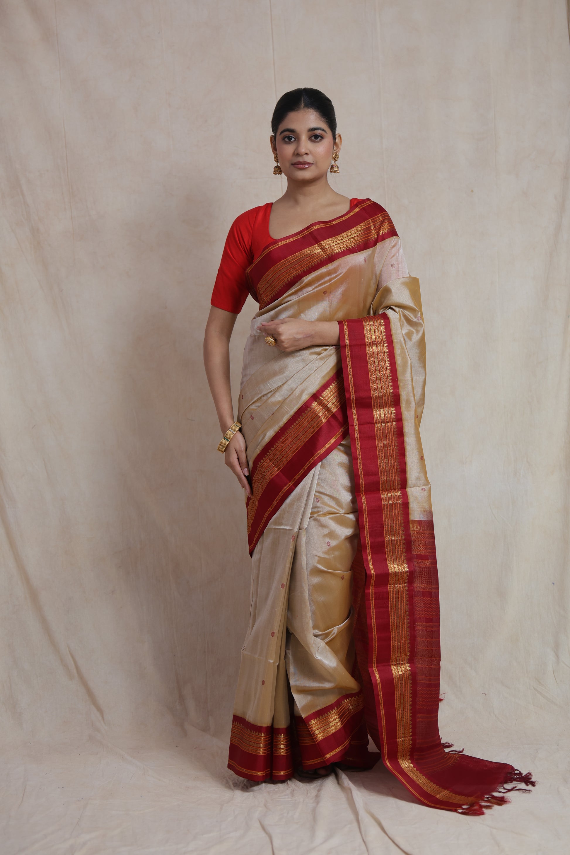 Model wearing elegant beige Kanchipuram Handloom SICO saree with maroon contrast border