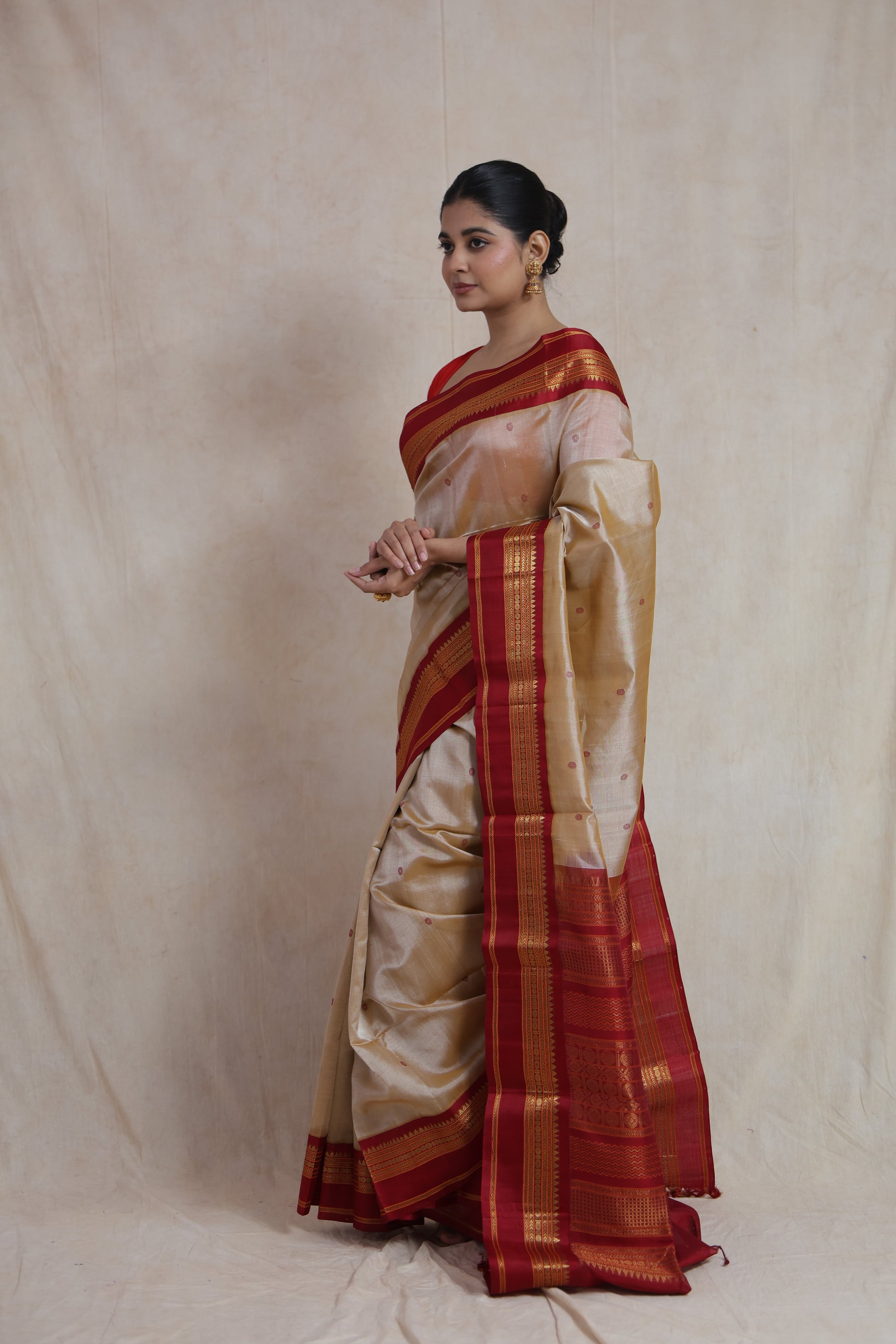 Side view of beige Kanchipuram Handloom SICO saree with maroon woven border