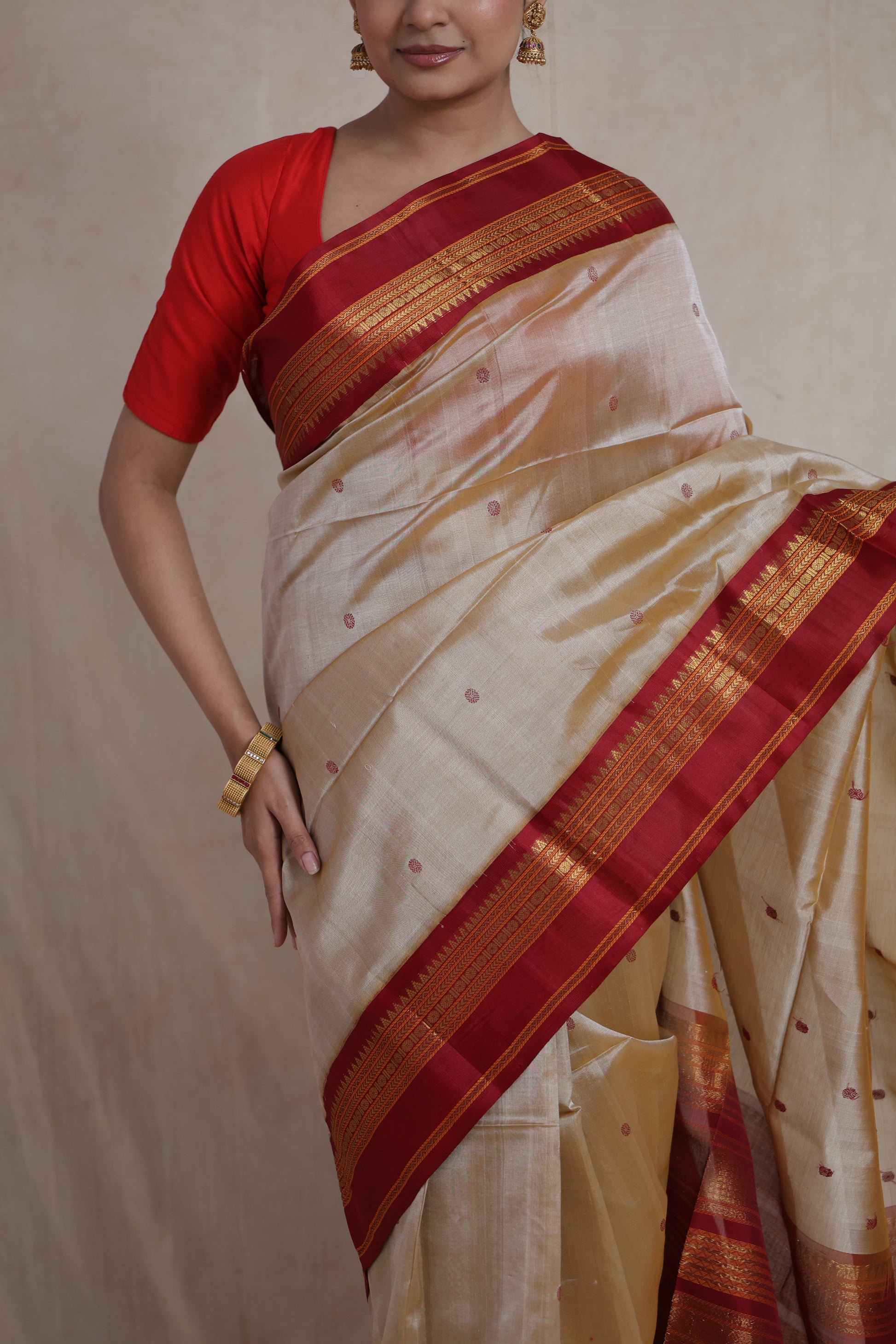 Close-up of beige Kanchipuram Handloom SICO saree highlighting woven buttas and maroon border