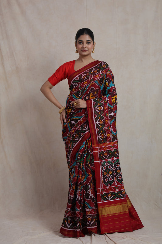 Full-length view of maroon Patola handloom silk saree with colorful heritage motifs and elegant border