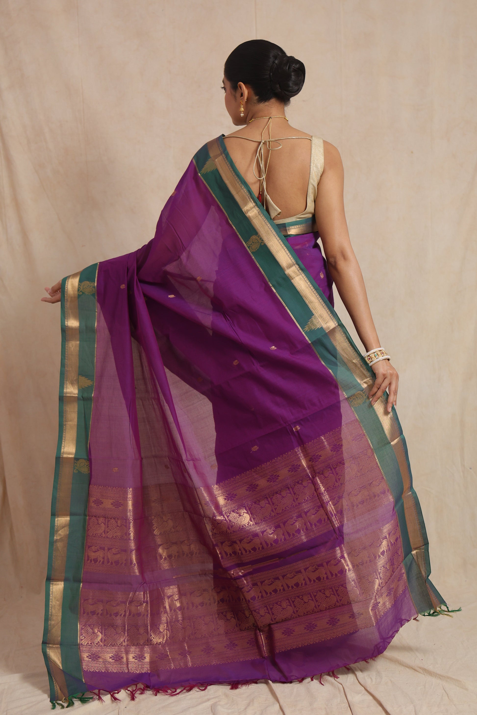 Back view of royal purple Kanchipuram handloom cotton saree with teal green border and traditional woven pallu