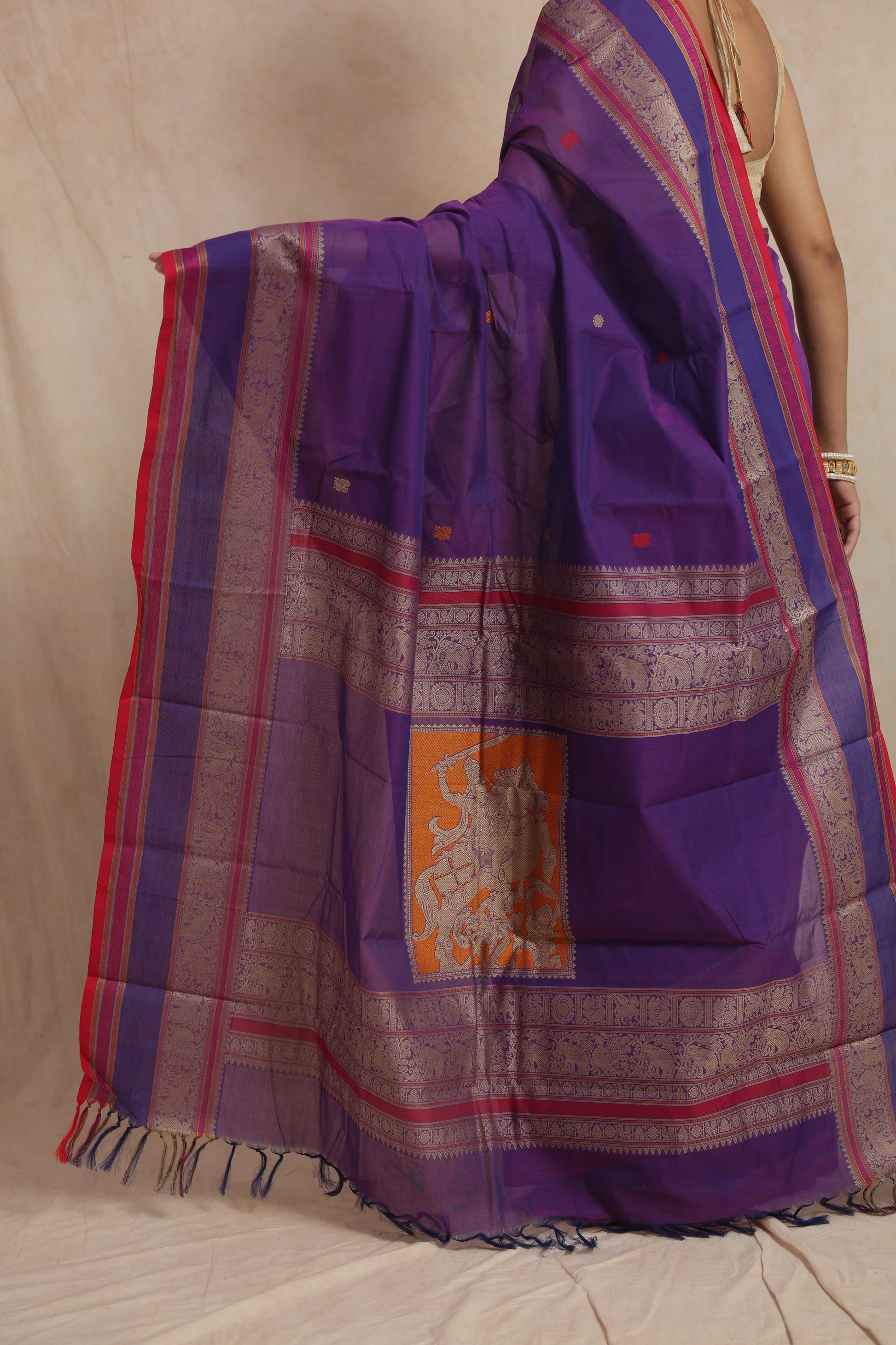 Traditional woven pallu of royal purple Kanchipuram handloom cotton saree with heritage motifs