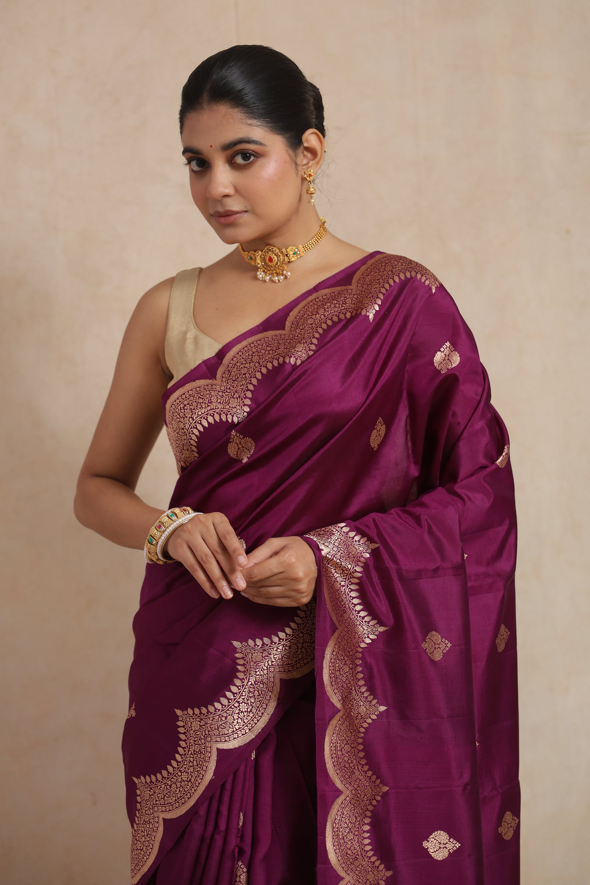 Detailed view of floral woven pallu and scalloped border on royal magenta Banarasi art silk saree