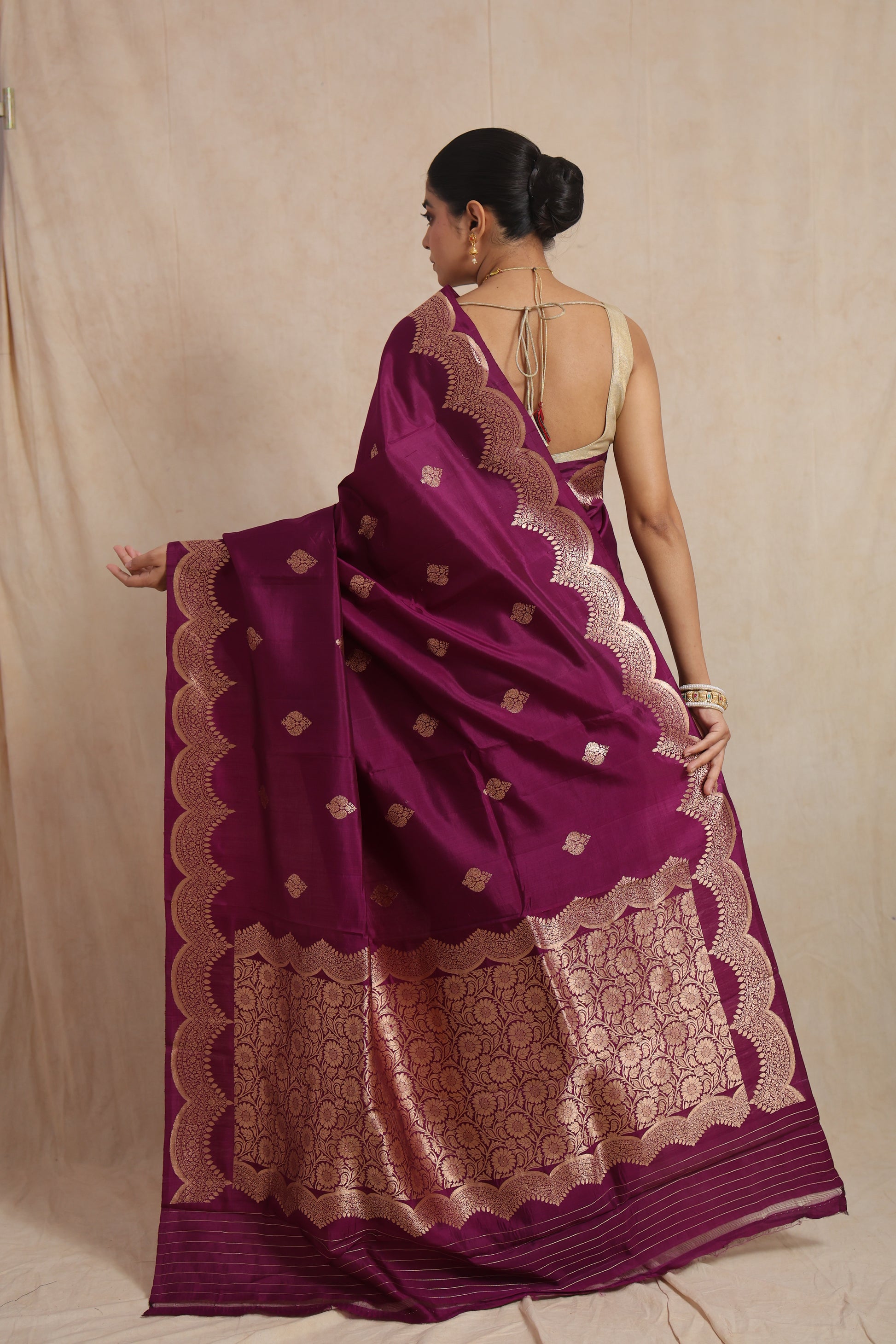 Back view of royal magenta Banarasi art silk saree highlighting the ornate floral woven pallu