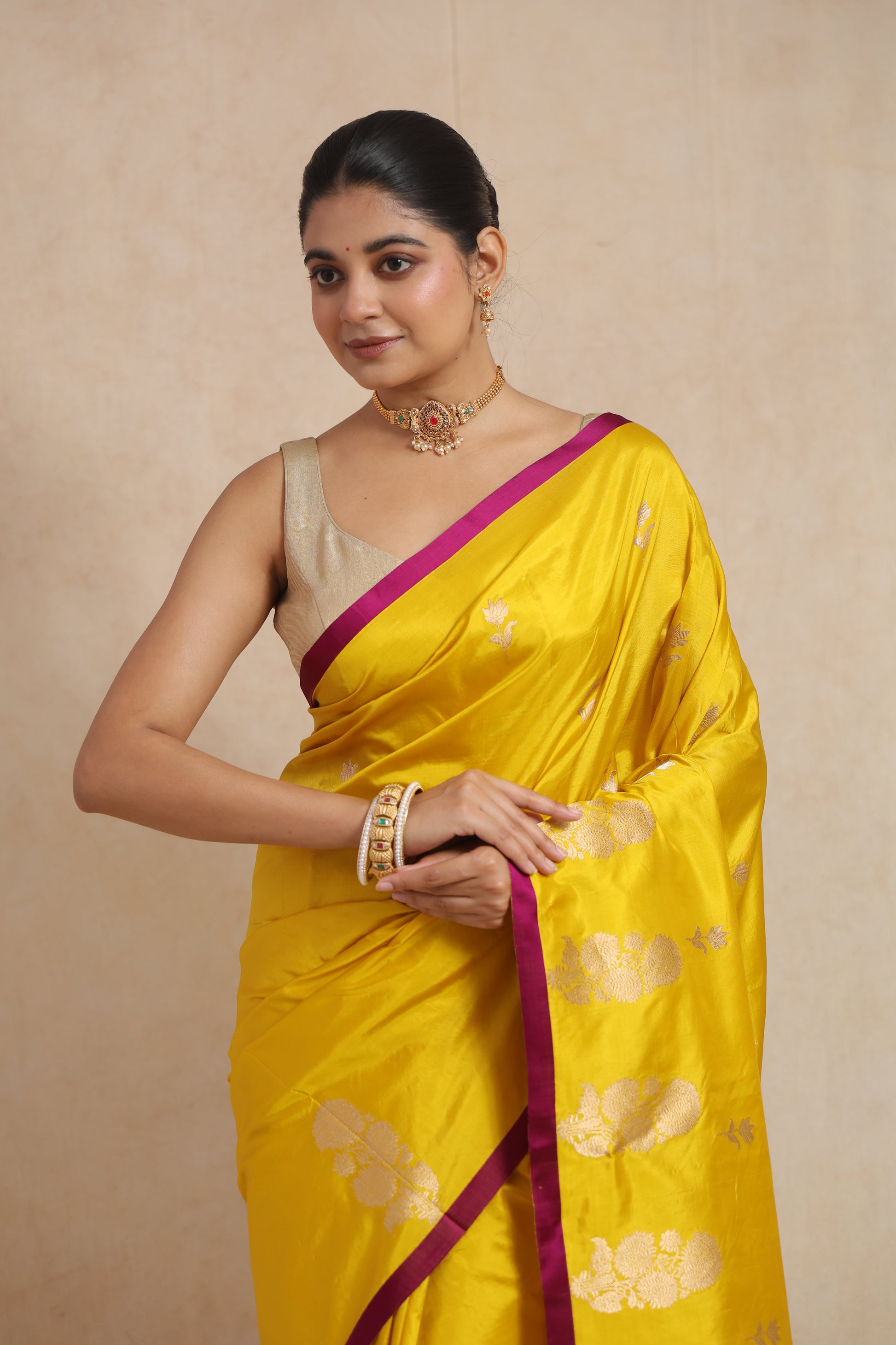 Close-up of the saree border and floral woven buttas on yellow Banarasi silk