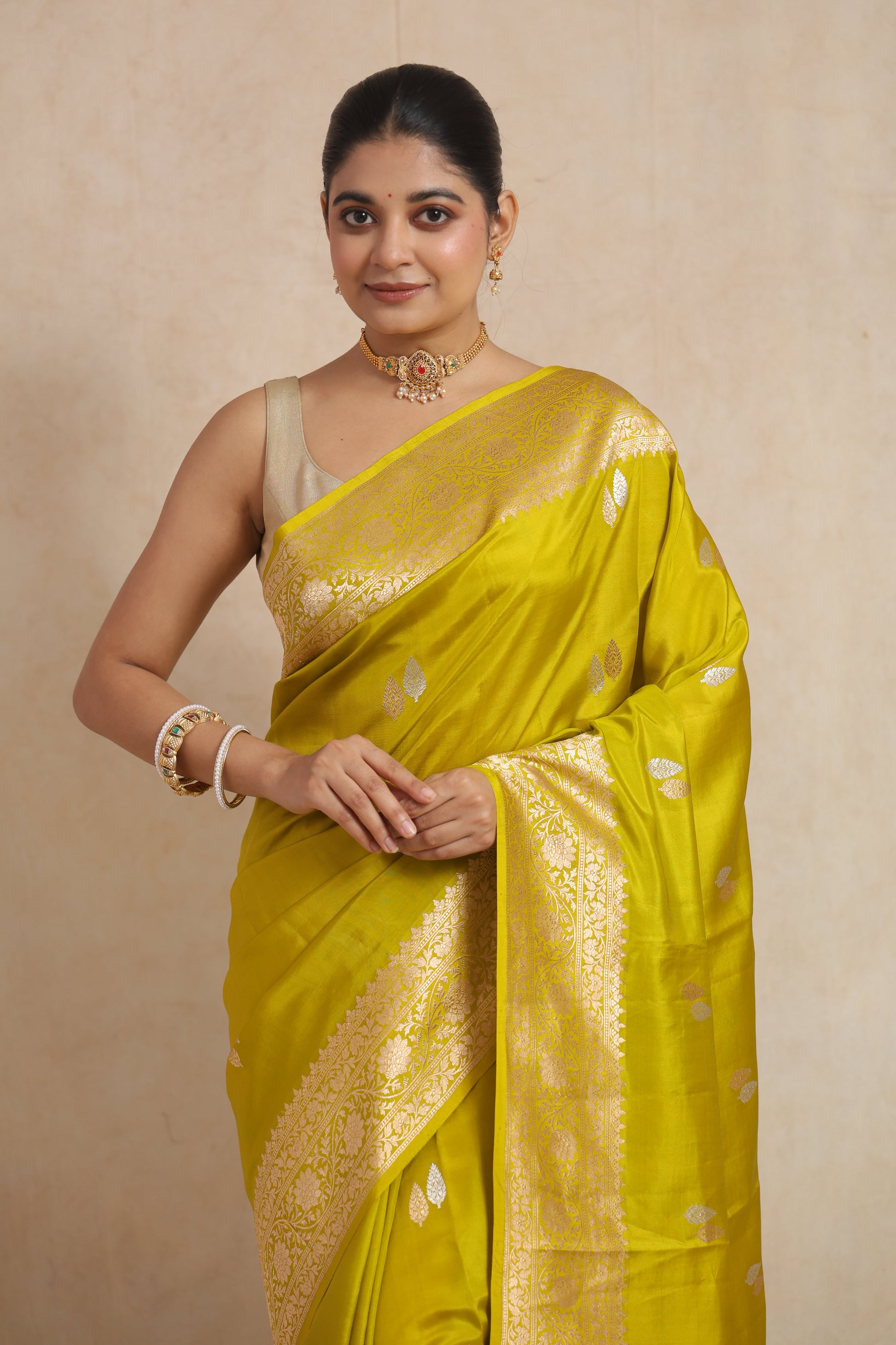 Close-up of Banarasi silk saree highlighting silver woven leaf motifs