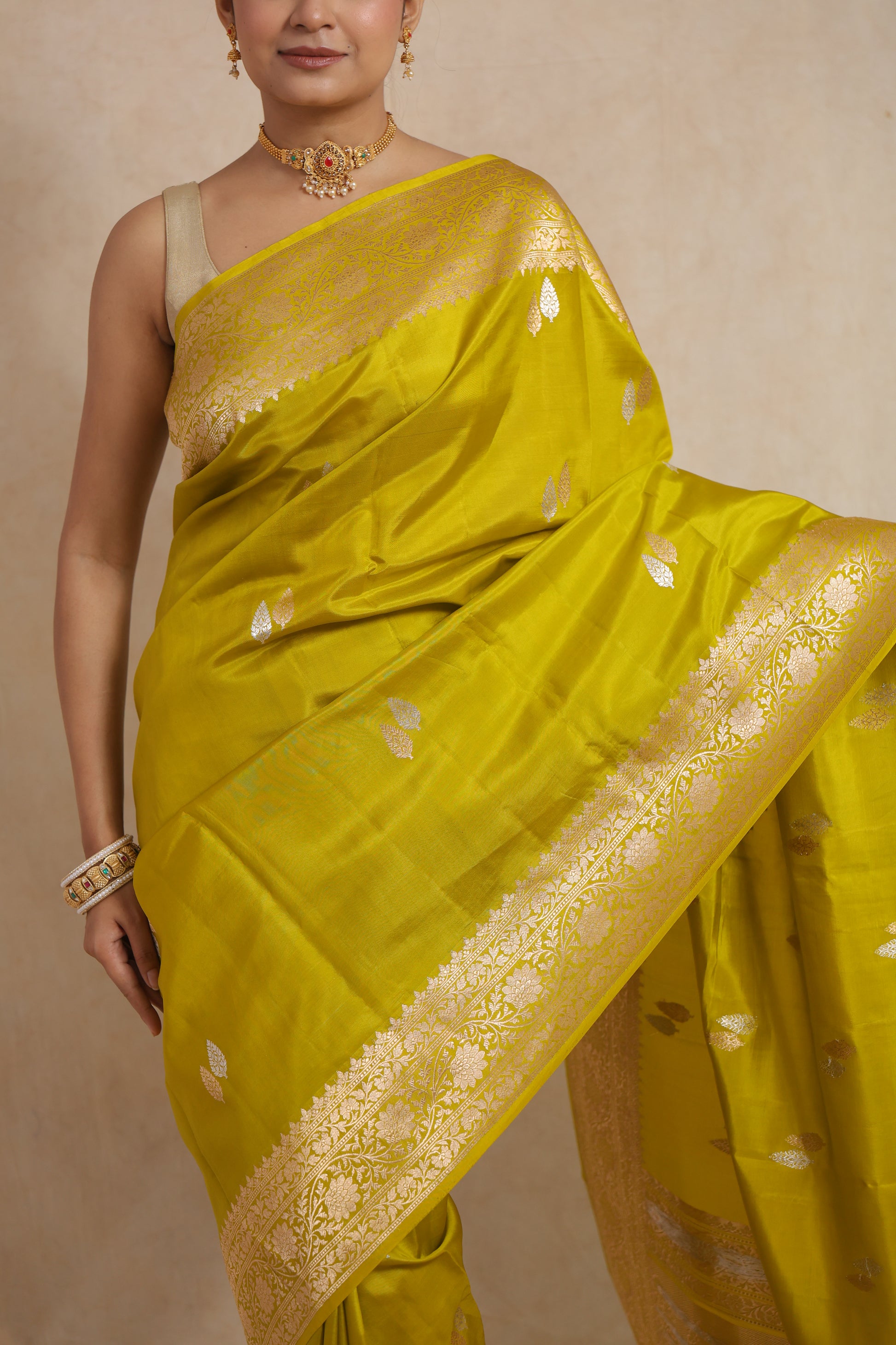 Close-up of Banarasi silk saree highlighting silver woven leaf motifs