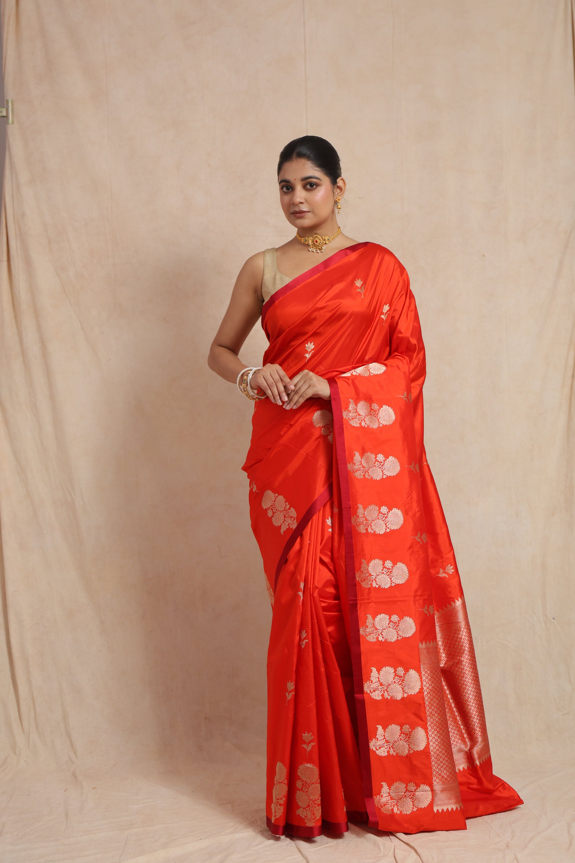 Full front view of vibrant vermilion Banarasi silk saree with traditional woven pallu