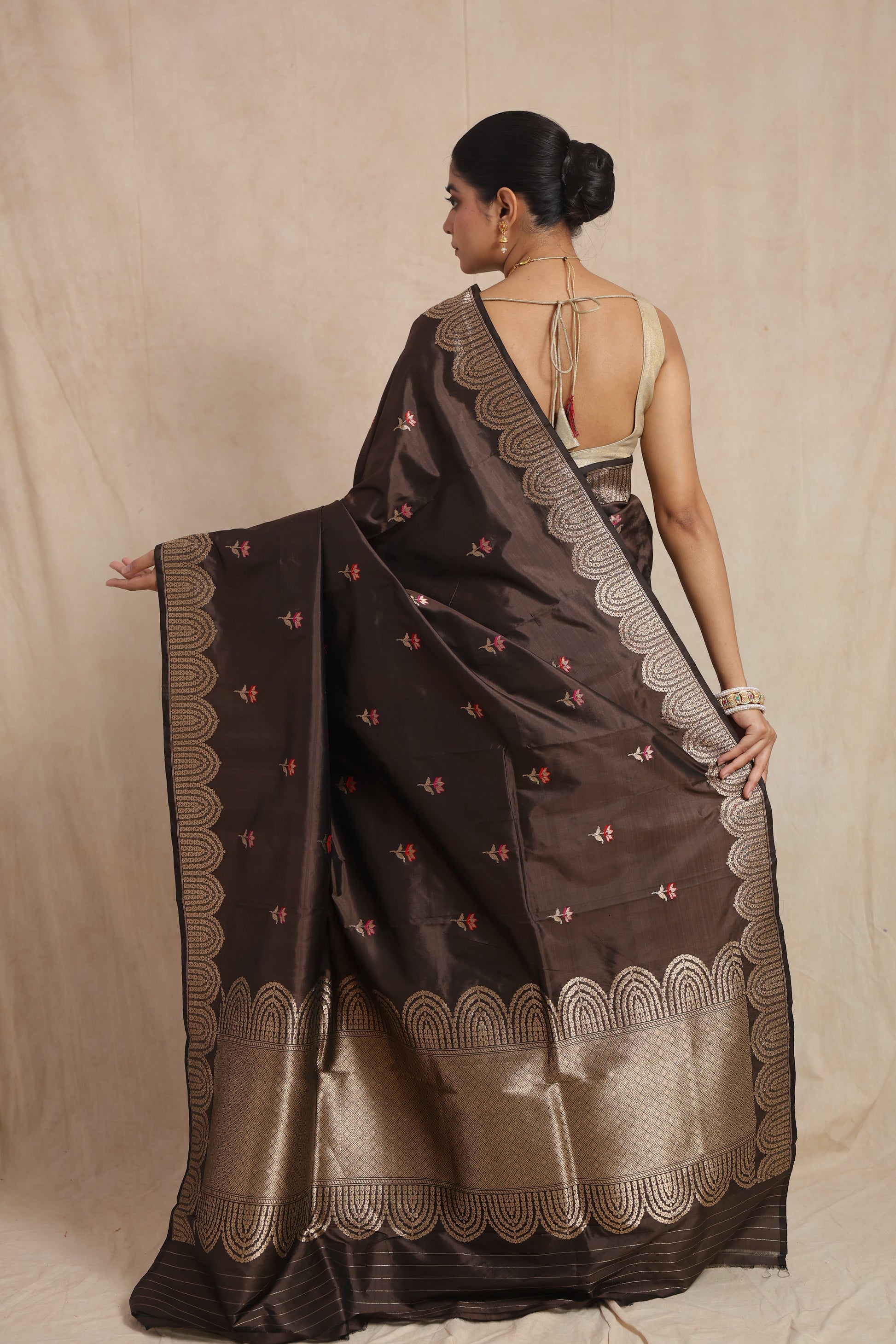 Back view of espresso brown Banarasi art silk saree featuring floral buttas, ornate woven border, and grand pallu