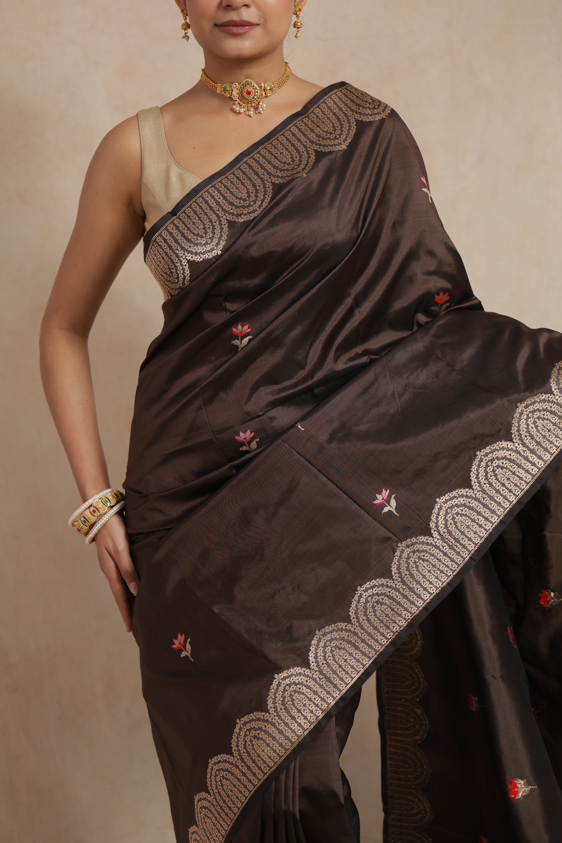 Close-up of espresso brown Banarasi art silk saree showcasing floral motifs and intricate woven border