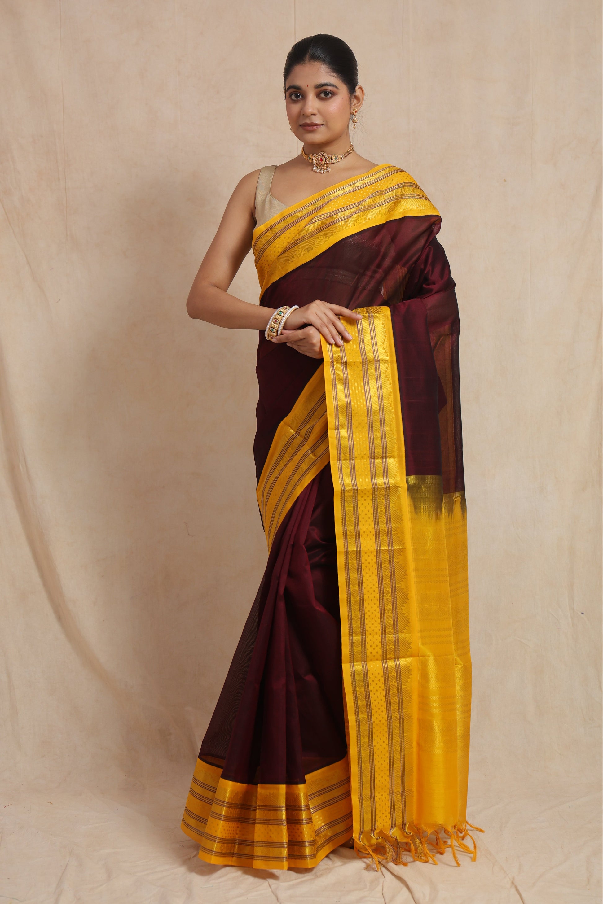 Front view of royal maroon Kanchipuram Handloom SICO saree with golden yellow traditional woven border