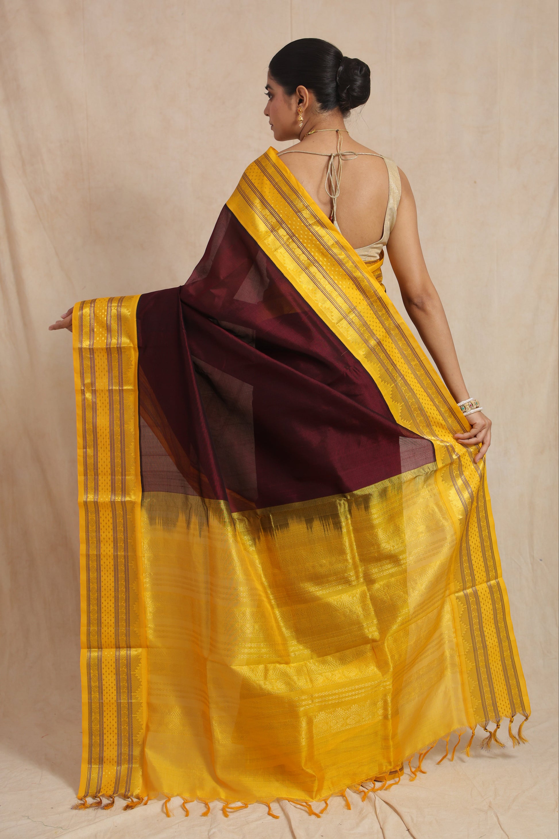Back view of maroon and golden yellow Kanchipuram Handloom SICO saree showcasing the elegant pallu