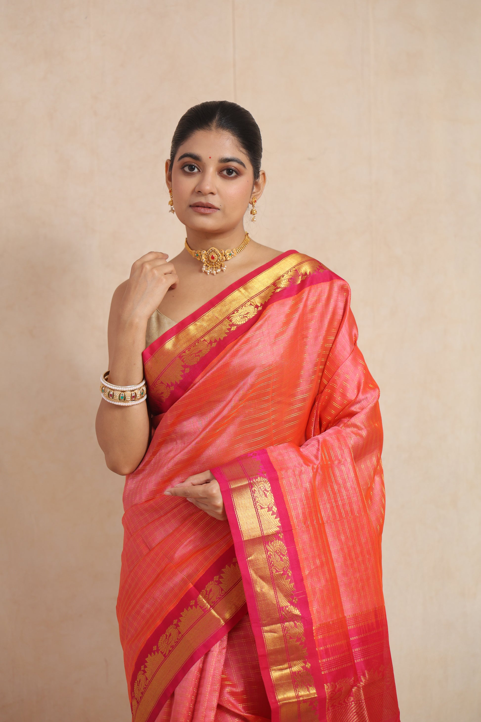 Close-up of coral pink Kanchipuram Handloom SICO saree highlighting the woven border and body