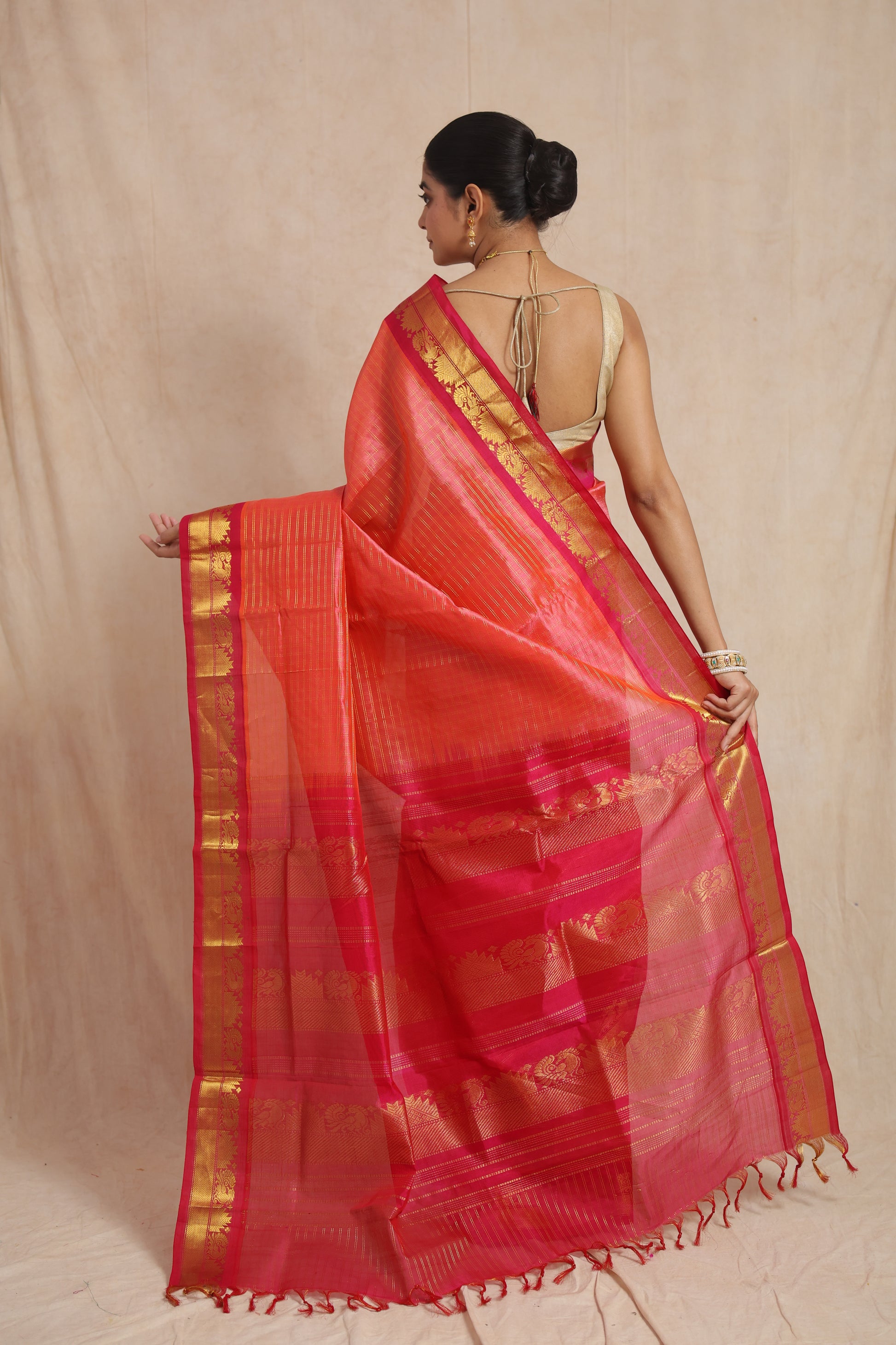 Back view showcasing the richly woven pallu of the coral pink Kanchipuram Handloom SICO saree