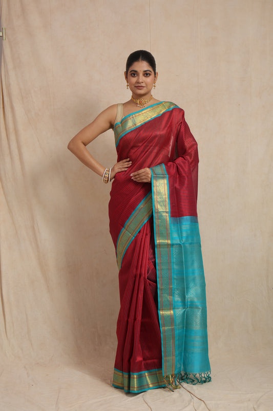Front view of maroon Kanchipuram SICO saree with aqua blue woven border and pallu