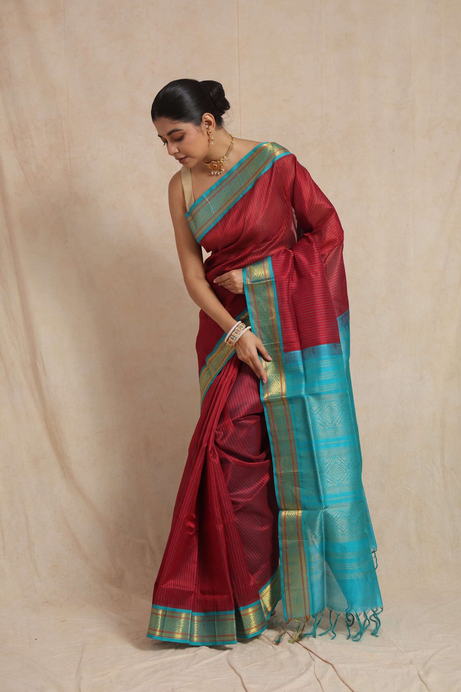 Elegant drape of maroon Kanchipuram SICO saree with contrasting aqua blue border