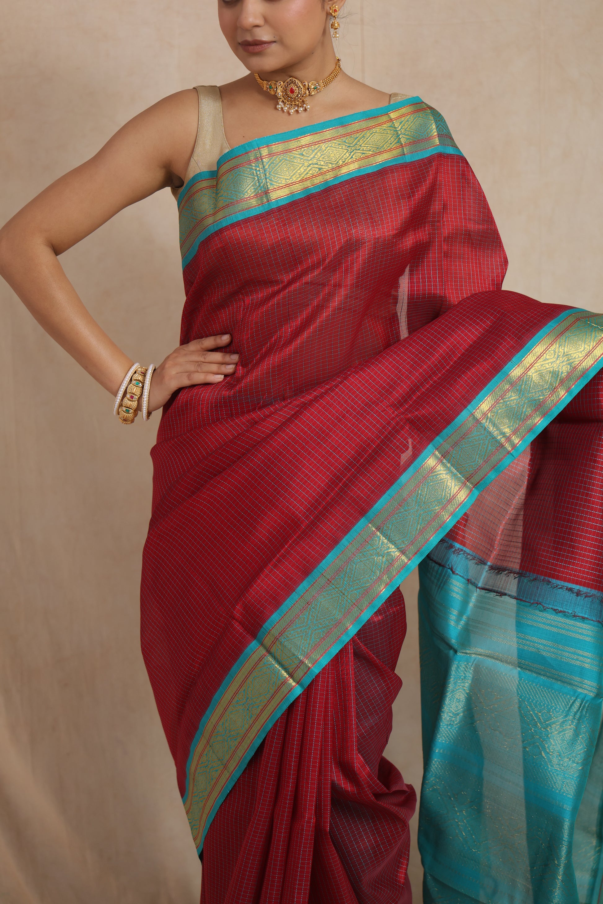 Detailed view of the woven aqua blue border and textured maroon body of the Kanchipuram SICO saree
