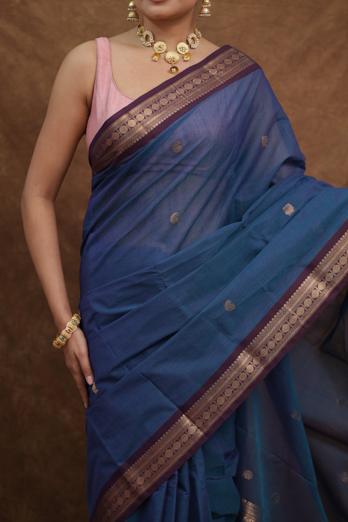 Beautiful denim blue Kanchipuram cotton saree with rust woven border, showcasing intricate weaving and traditional craftsmanship.