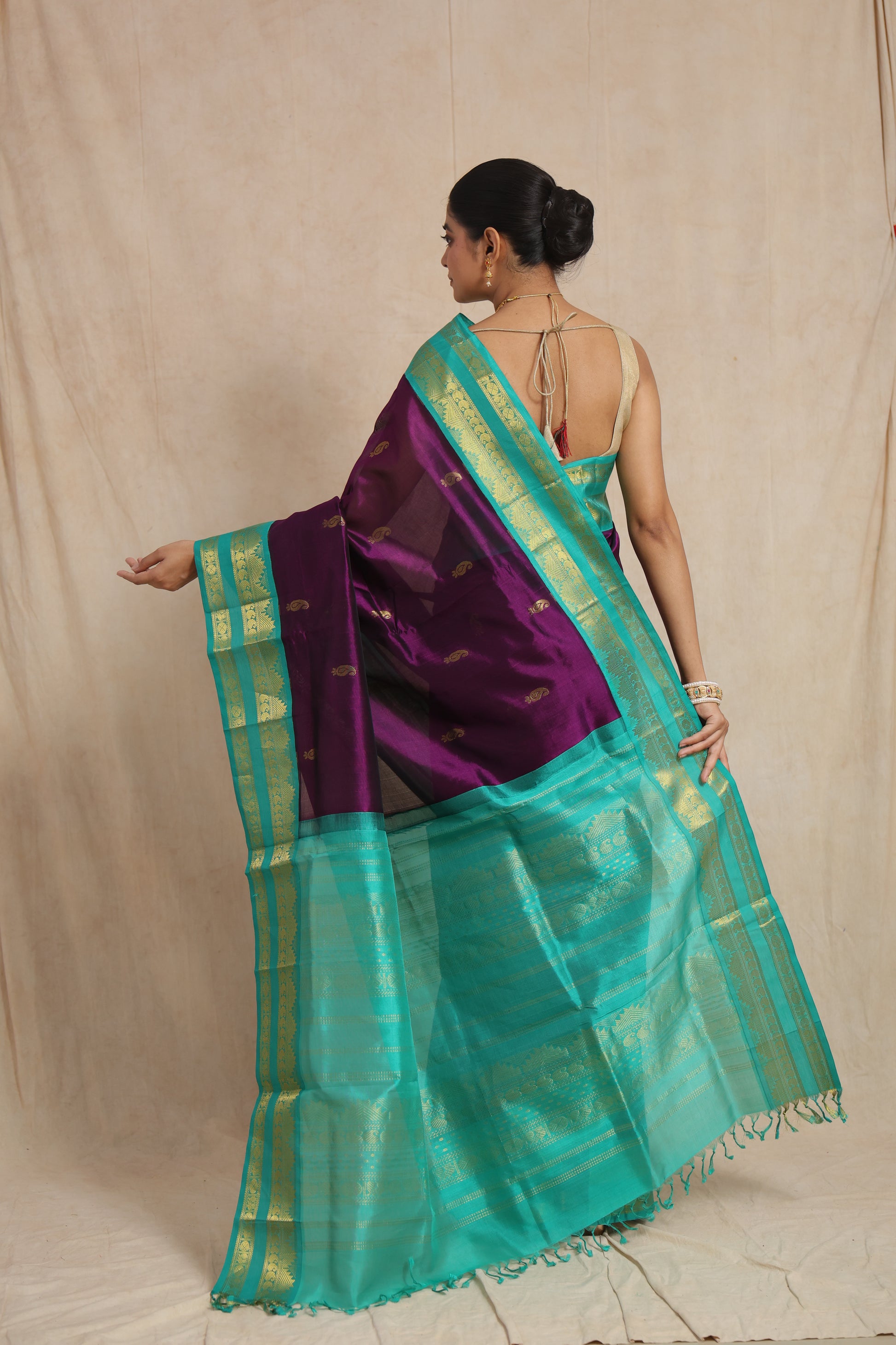 Back drape view of royal purple Kanchipuram Sico saree with aqua blue pallu