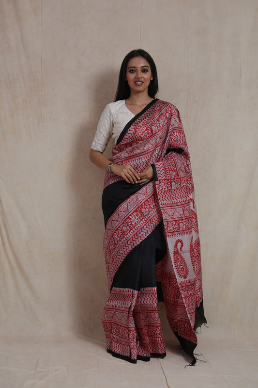 Model wearing black Batik silk saree with red floral and paisley printed border