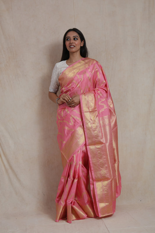 Blush pink Kanchipuram silk saree with gold woven motifs and rich border