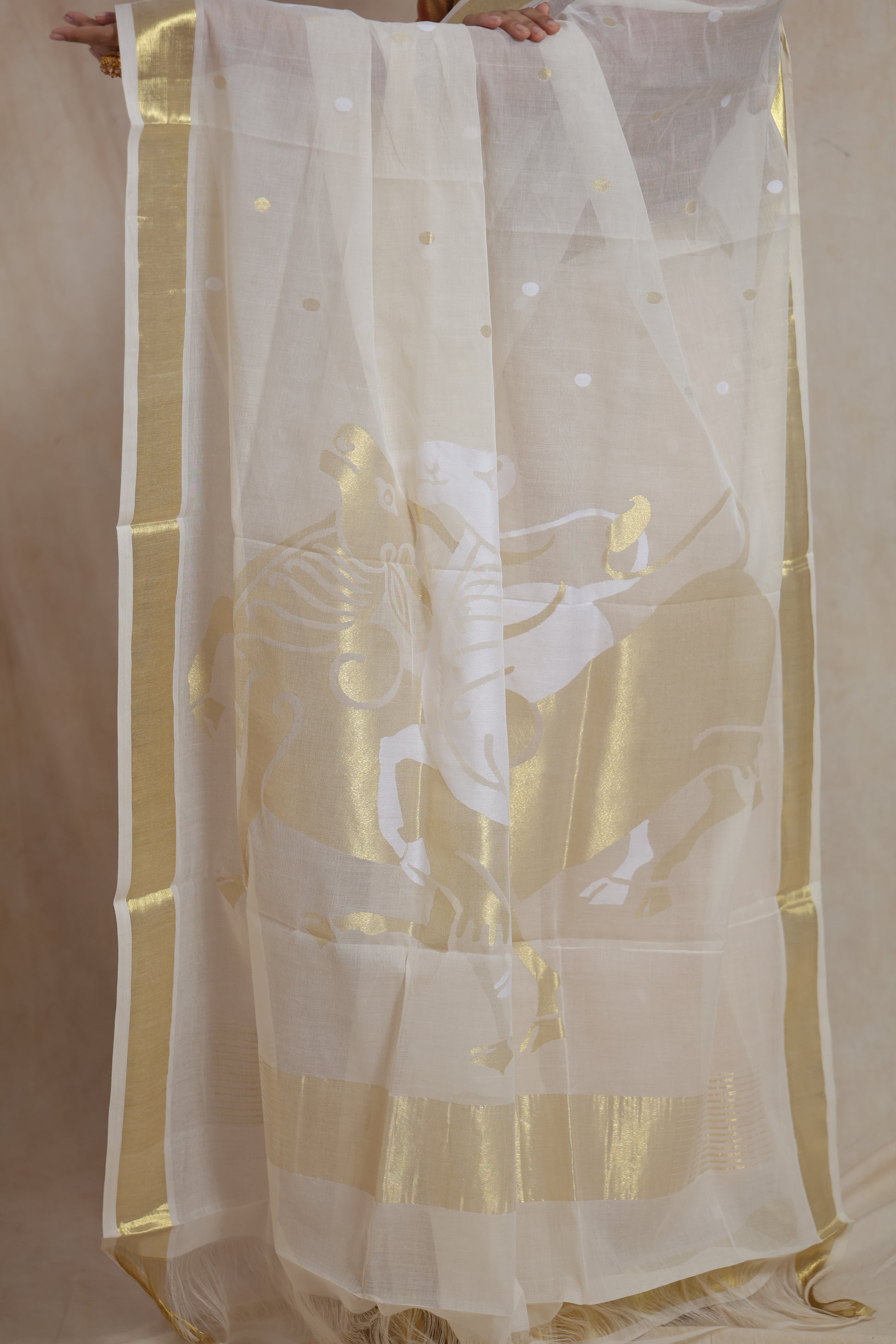 Off white Kanchipuram cotton saree with golden peacock motif pallu
