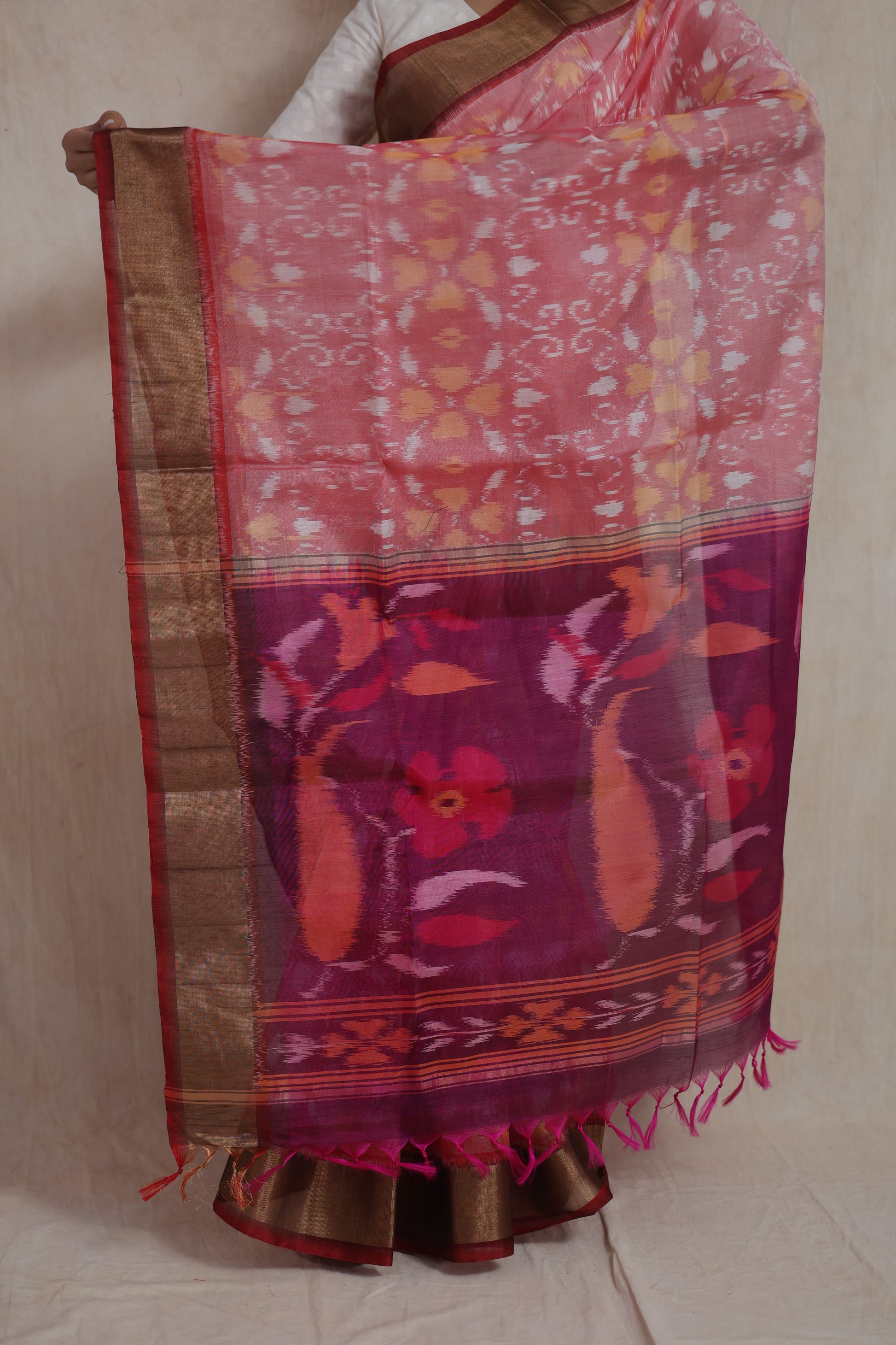 Drape close-up of pink Pochampally silk cotton saree with intricate Ikat motifs and pallu view