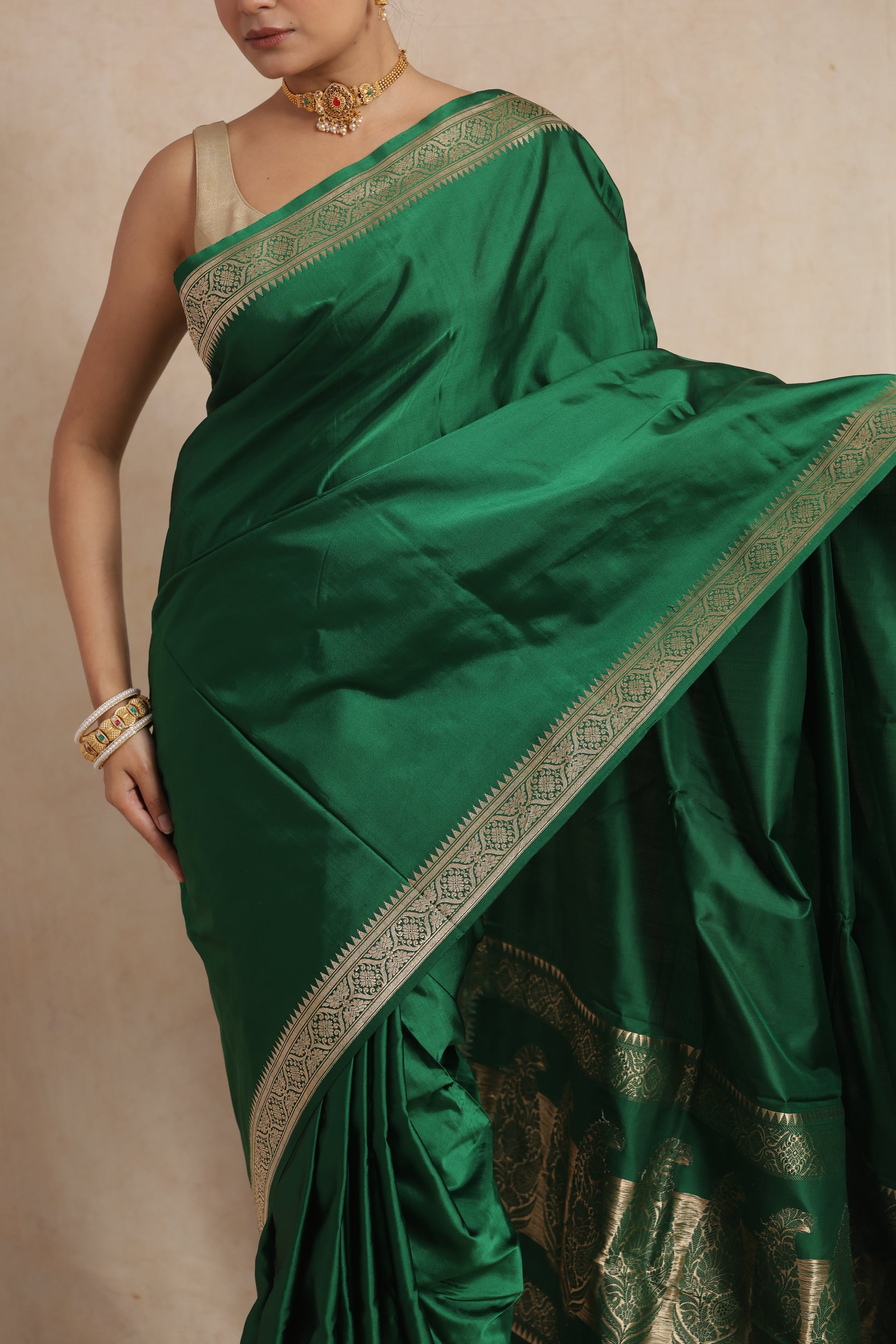 Detailed close-up of emerald green Banarasi art silk saree with elegant woven craftsmanship