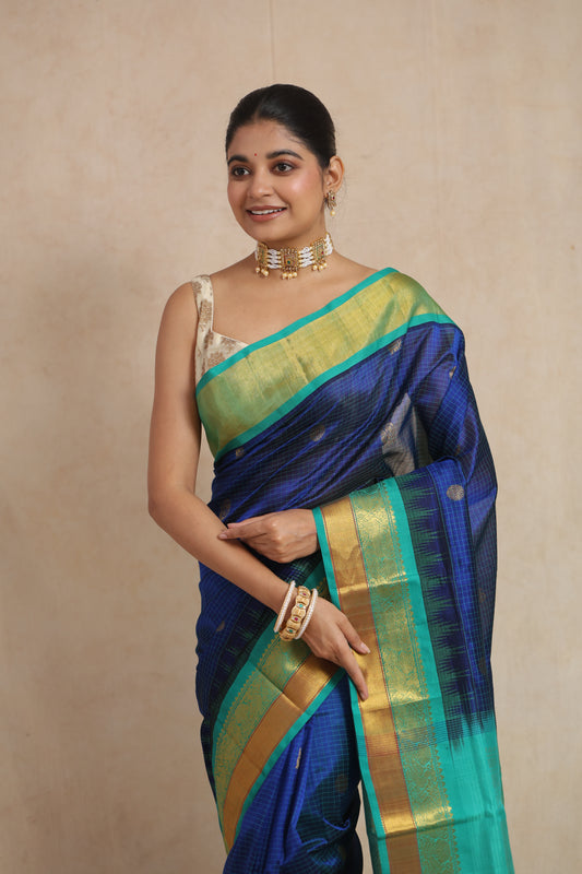 Portrait view of royal blue Kanchipuram Sico saree with aqua green woven border
