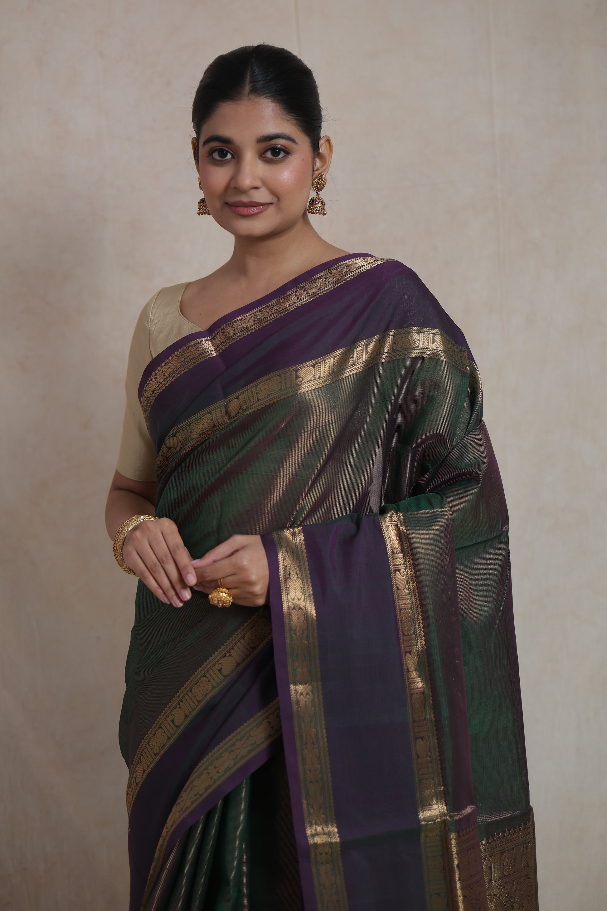 Portrait view of luxurious green and purple Kanchipuram silk saree