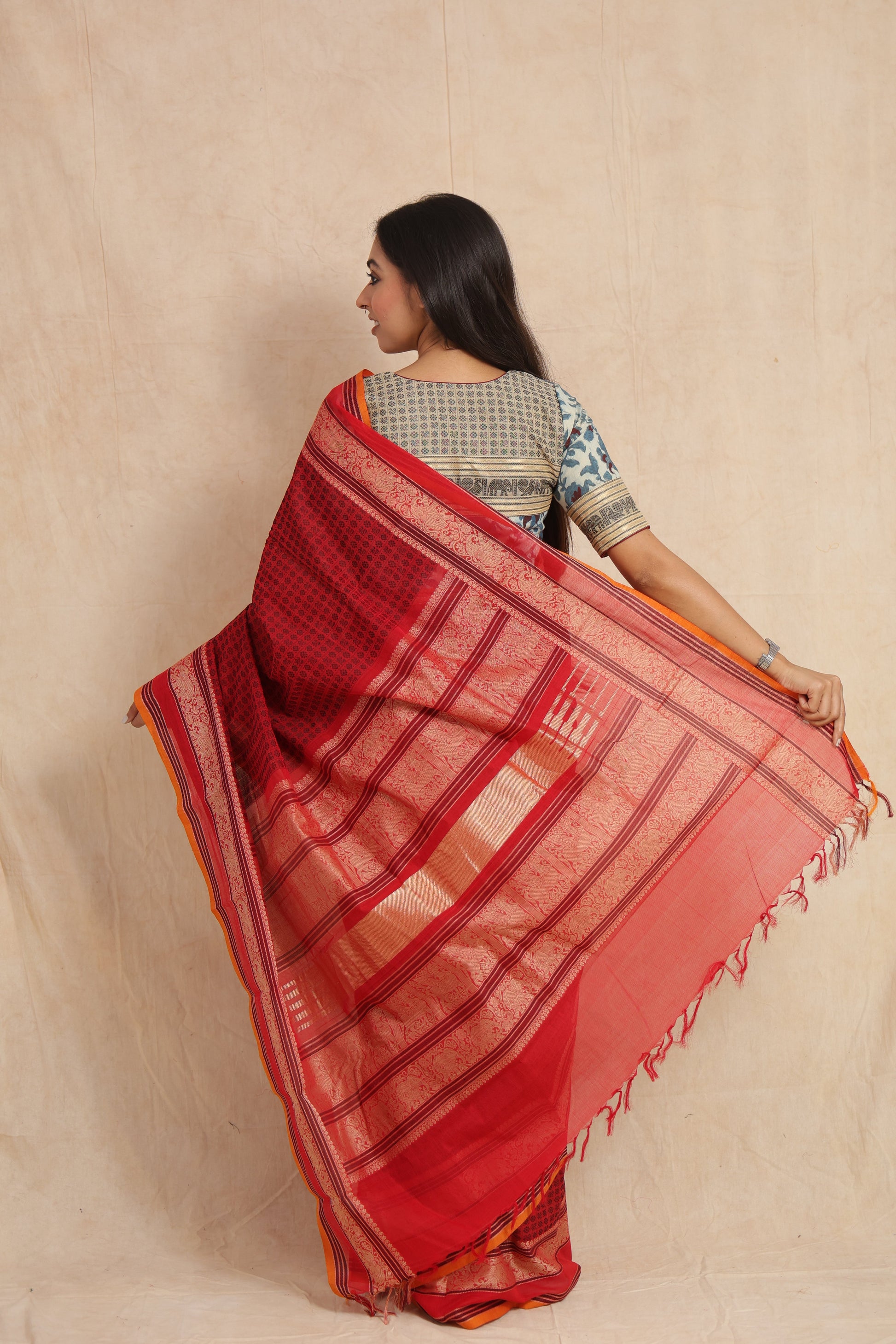 Back view of ruby red Kanchipuram cotton saree with rich woven pallu