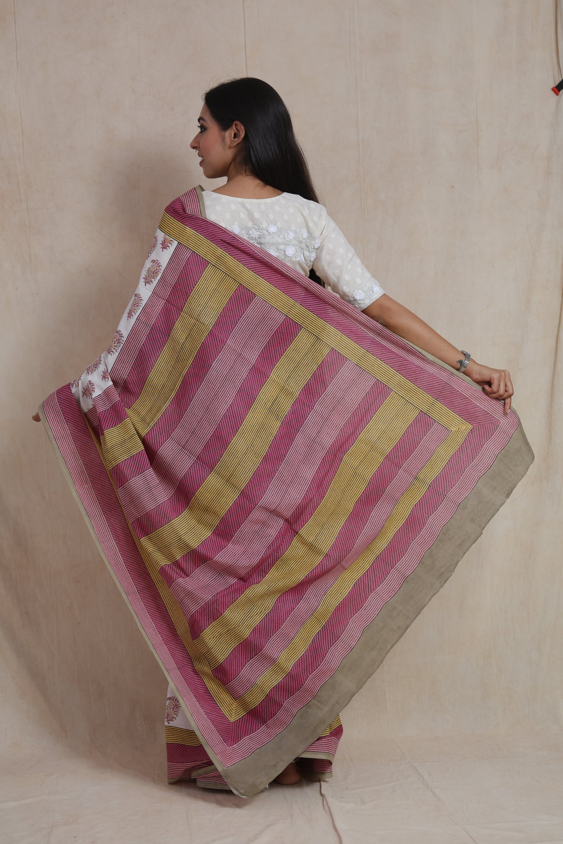 Back pallu view of white Sanghnaree cotton saree with pink and mustard stripes