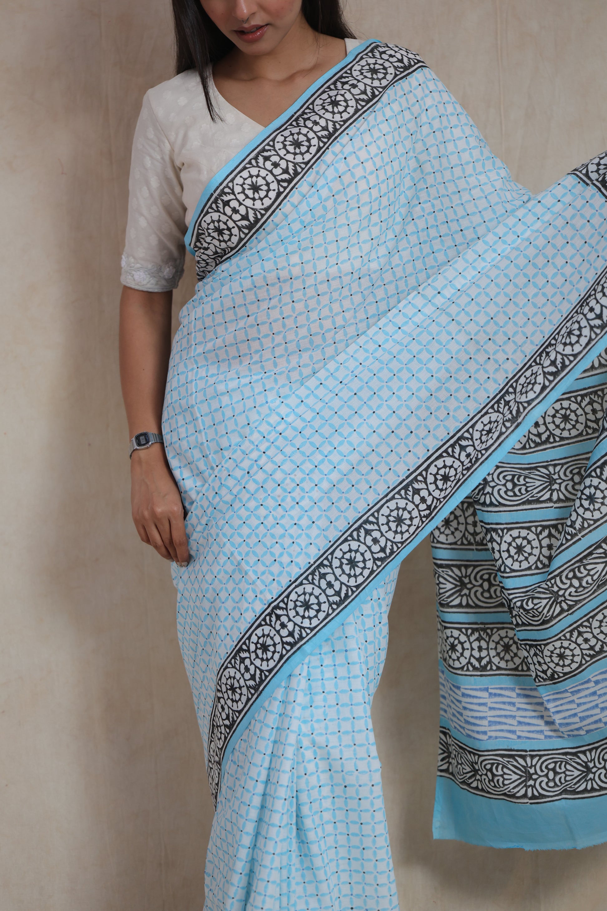 Close-up of sky blue Sanghnaree cotton saree with black floral border print
