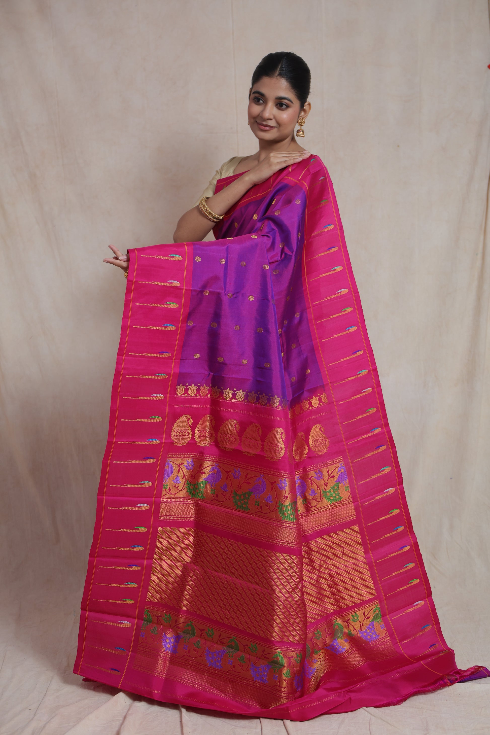 Side pose featuring royal purple Gadwal Silk saree with rich woven pallu