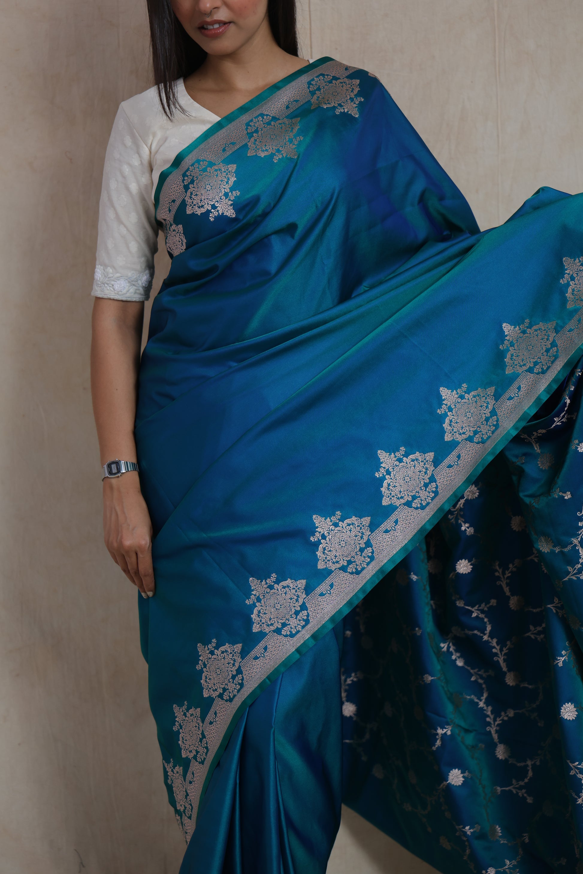 Detailed closeup of teal blue Banarasi art silk saree with woven floral motifs