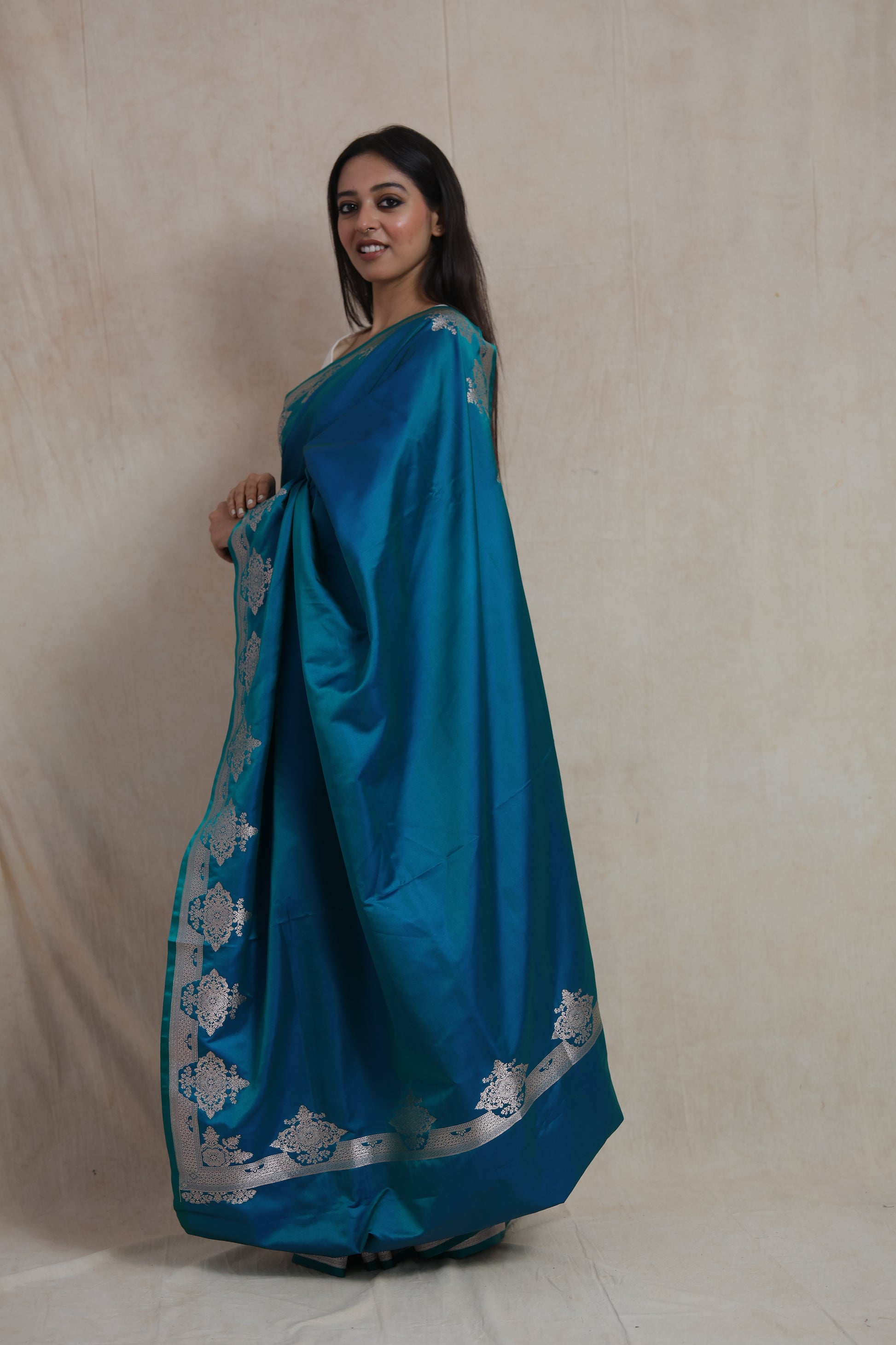 Side profile of teal blue Banarasi art silk saree with silver zari detailing