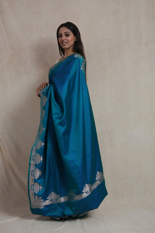 Side profile of teal blue Banarasi art silk saree with silver zari detailing