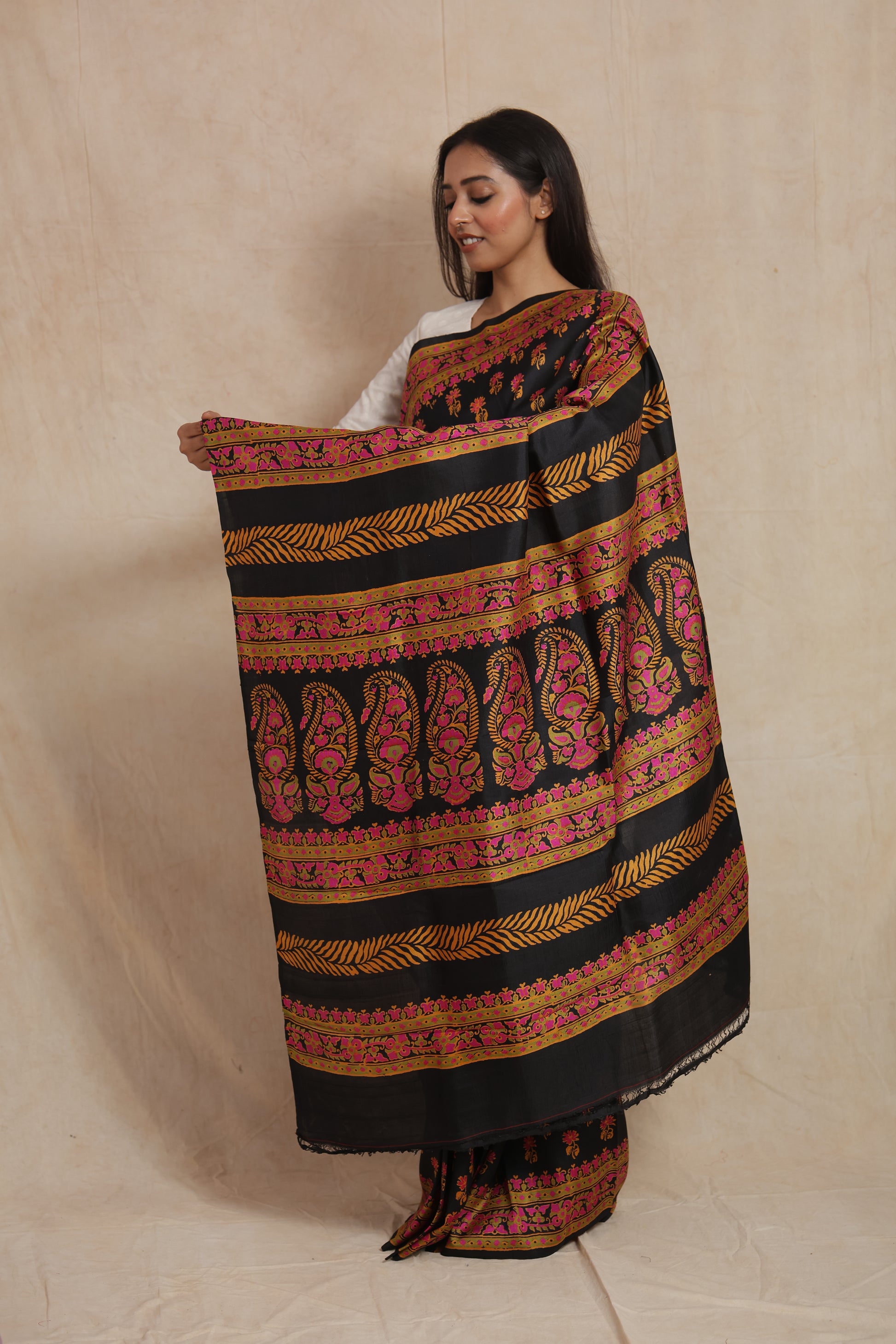 Detailed pallu design of black Batik silk saree with floral and paisley motifs
