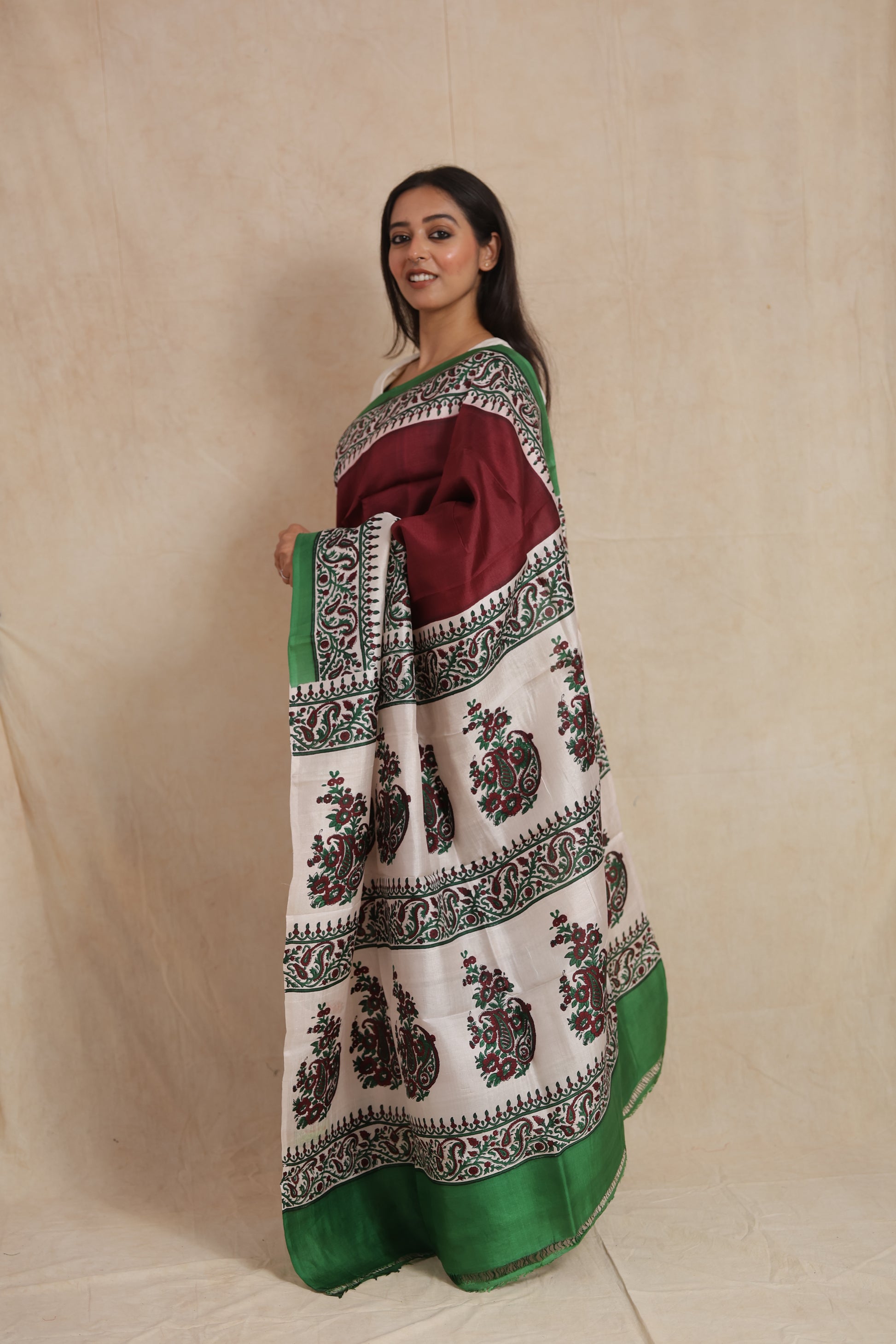 Side profile view of maroon Batik silk saree with artistic printed border