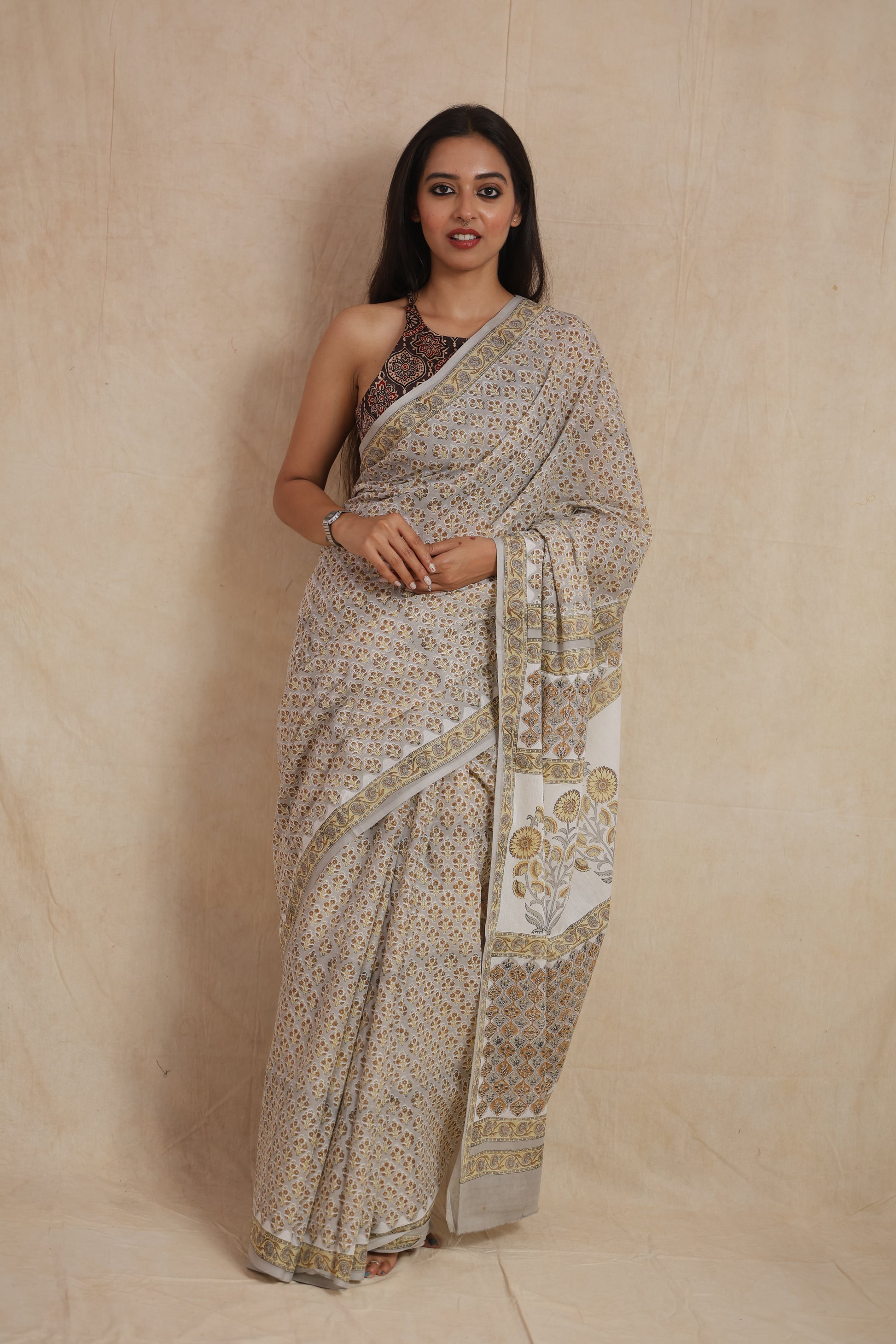 Full front view of beige floral Sanghaneri cotton saree