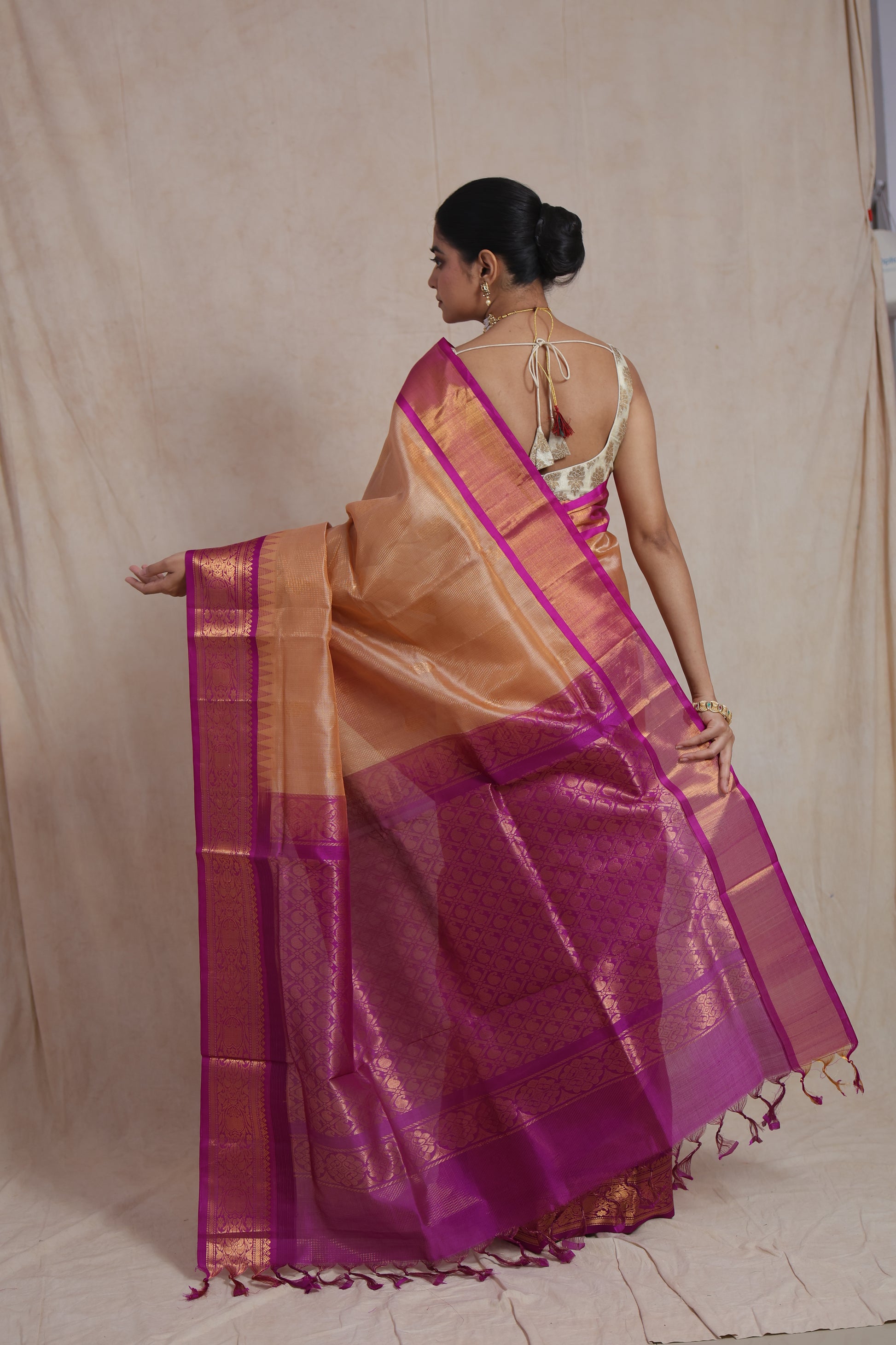 Back pallu view of golden beige Kanchipuram Sico saree with magenta woven detailing