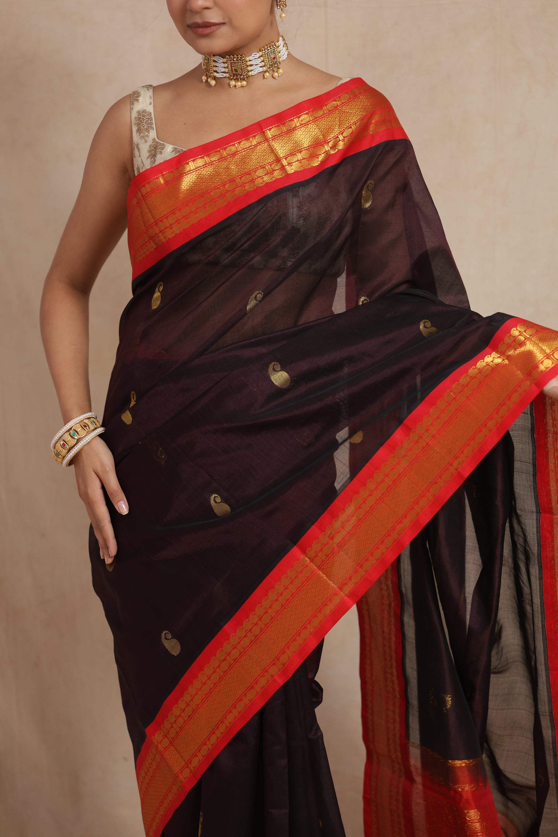 Detailed pallu of black Kanchipuram Sico saree with traditional golden zari weaving