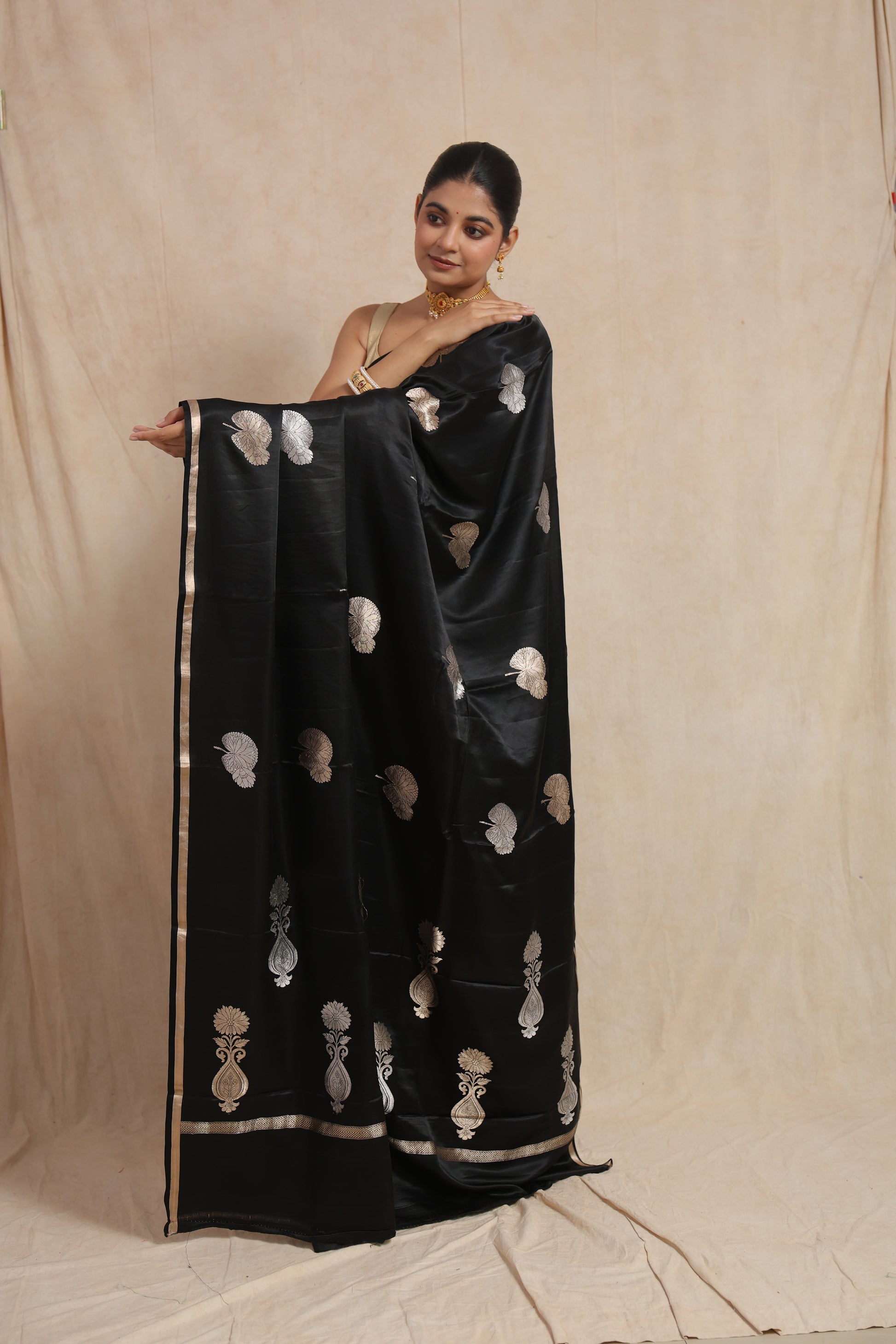 Traditional pallu display of black Banarasi silk saree with silver floral weaving